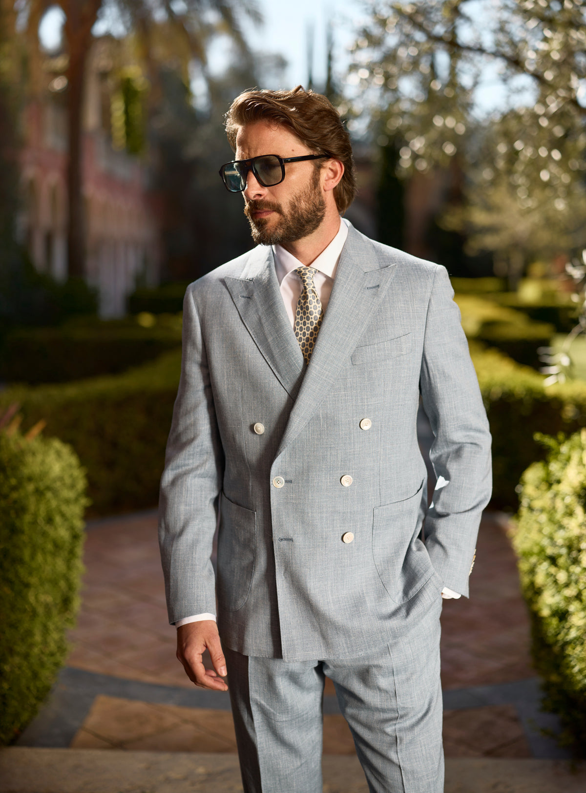 Light blue-grey double-breasted Consiglieri suit worn with a patterned tie