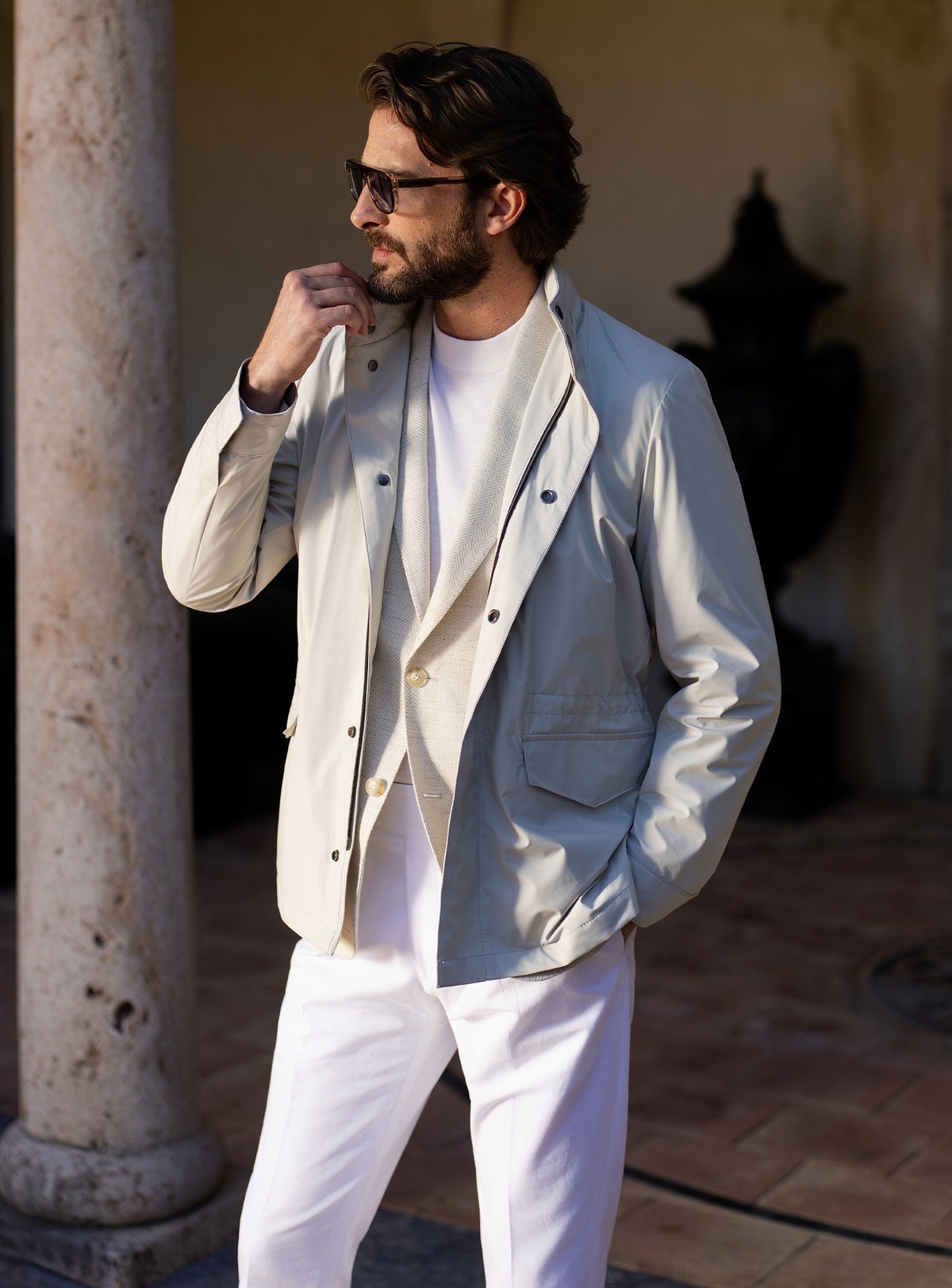 Light grey Consiglieri four-pocket jacket worn with a white T-shirt and white trousers