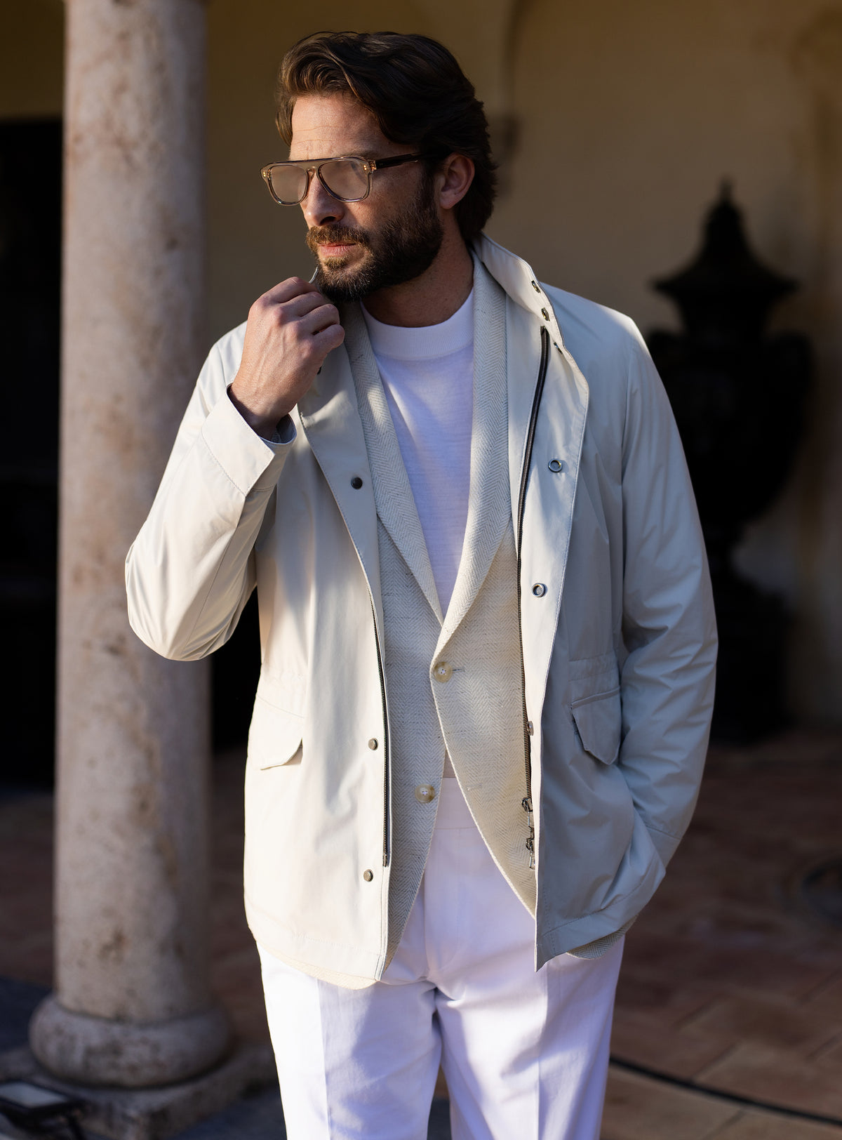 Light grey Consiglieri four-pocket jacket worn with a white T-shirt and white trousers