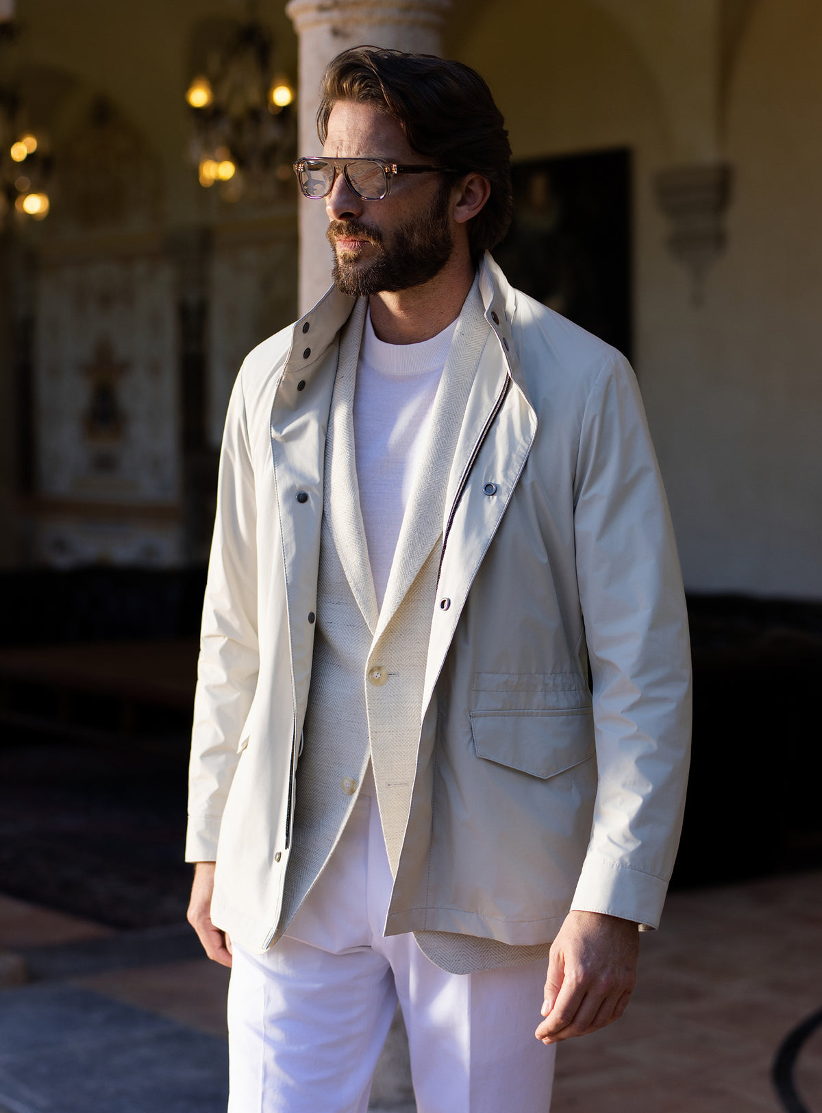 Light grey Consiglieri four-pocket jacket worn with a white T-shirt and white trousers