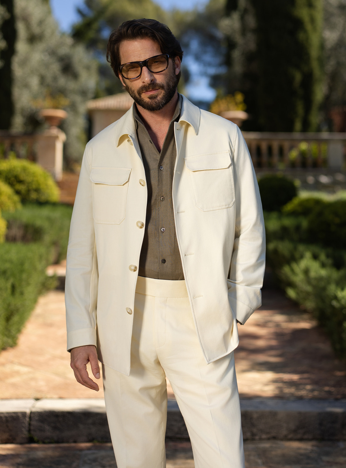 Cream Consiglieri ensemble with a patch-pocket jacket over a khaki shirt