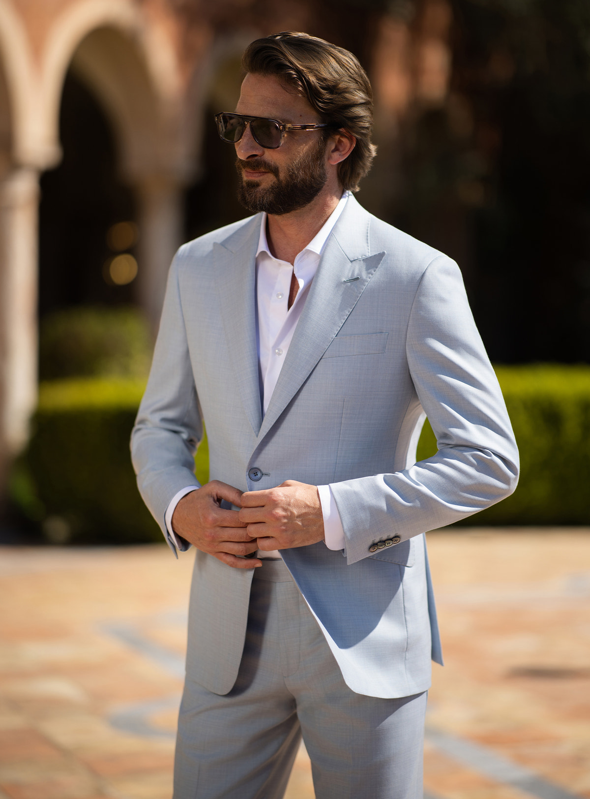 Pale blue Consiglieri suit worn with an open-neck white shirt and brown loafers