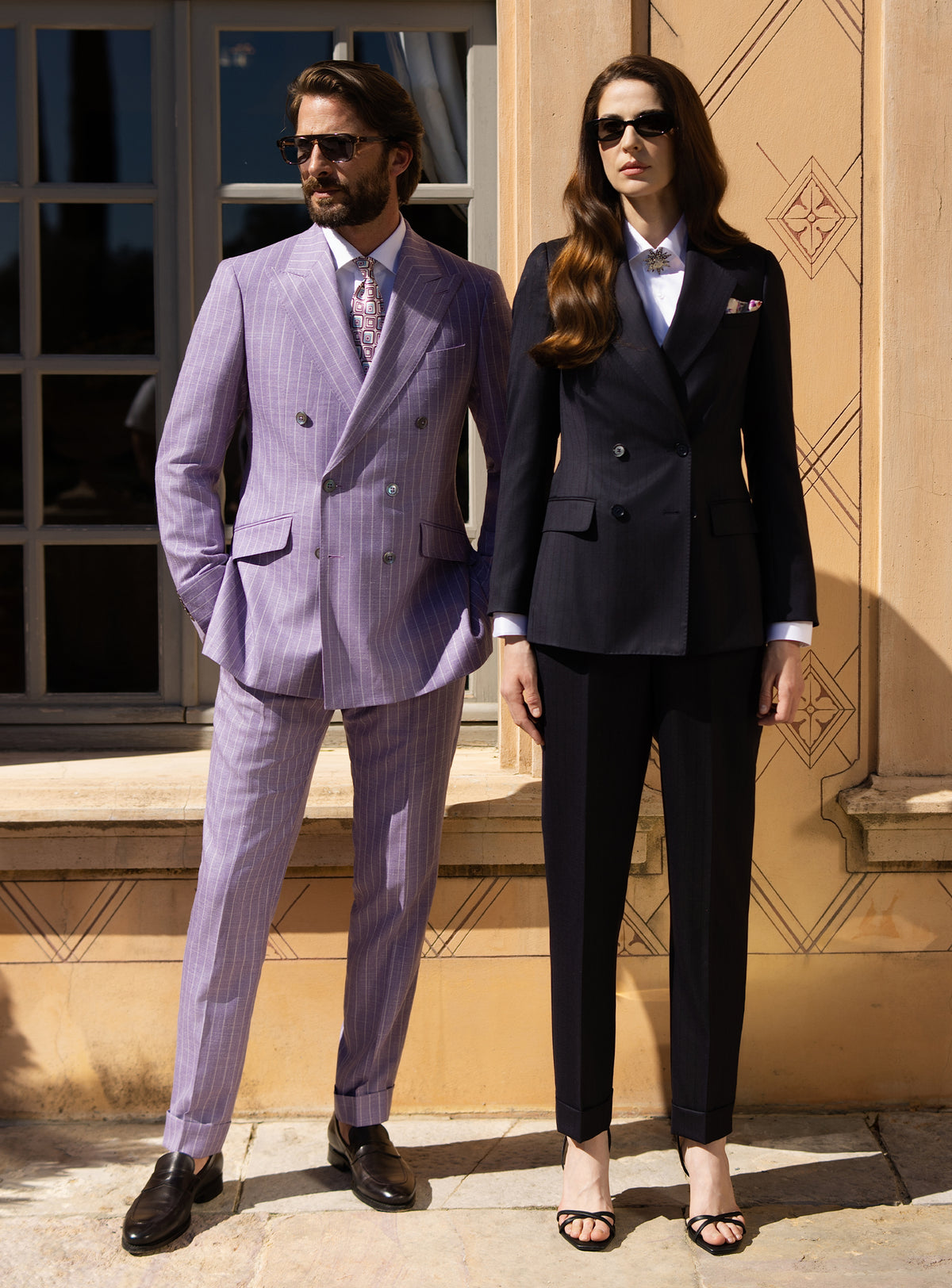 Lilac men's suit and navy women's suit by Consiglieri, styled as a couple