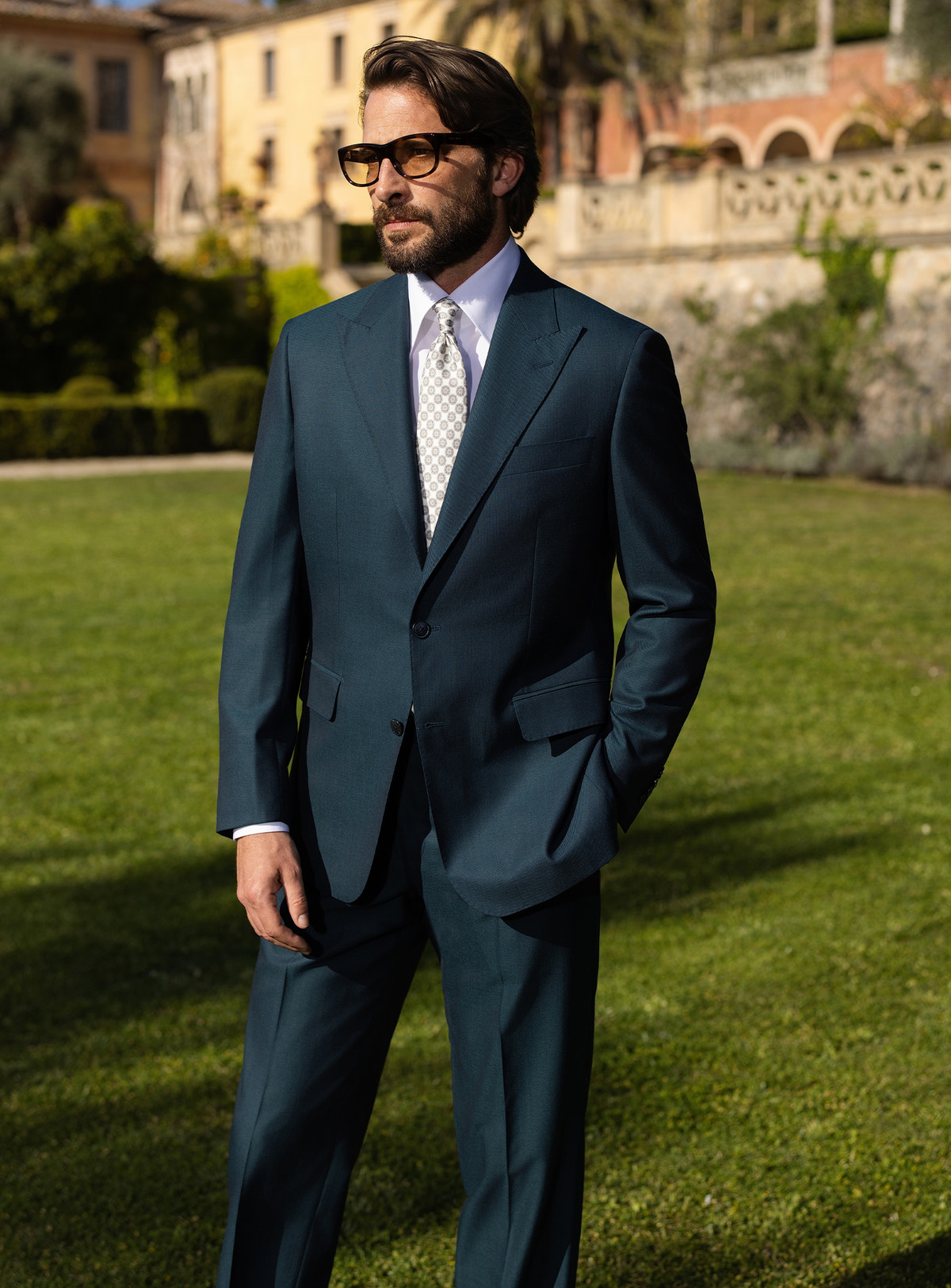 Deep teal Consiglieri suit worn with a white shirt and patterned tie
