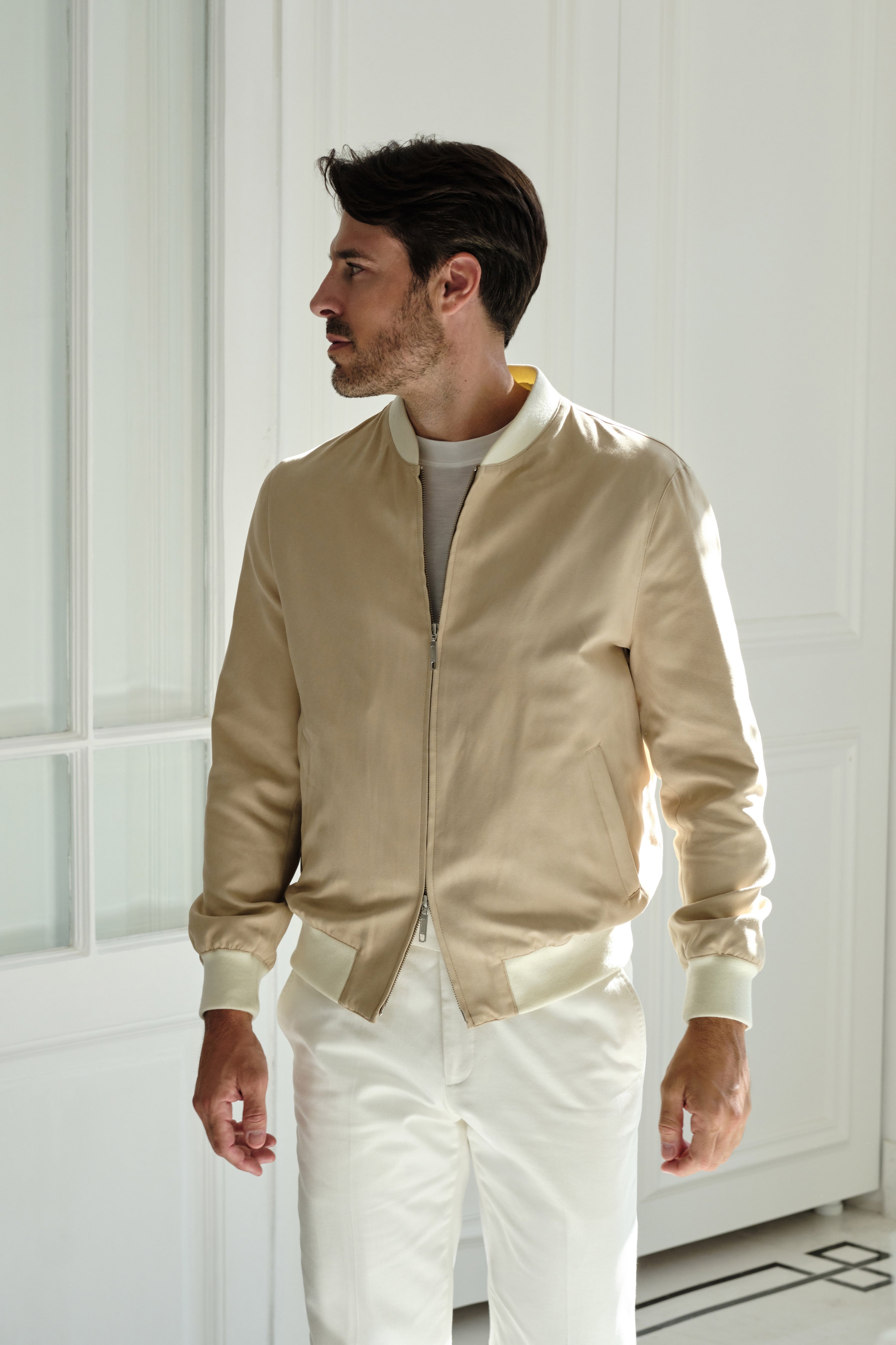 Sand Bomber jacket worn in a luminous outfit, photographed indoors