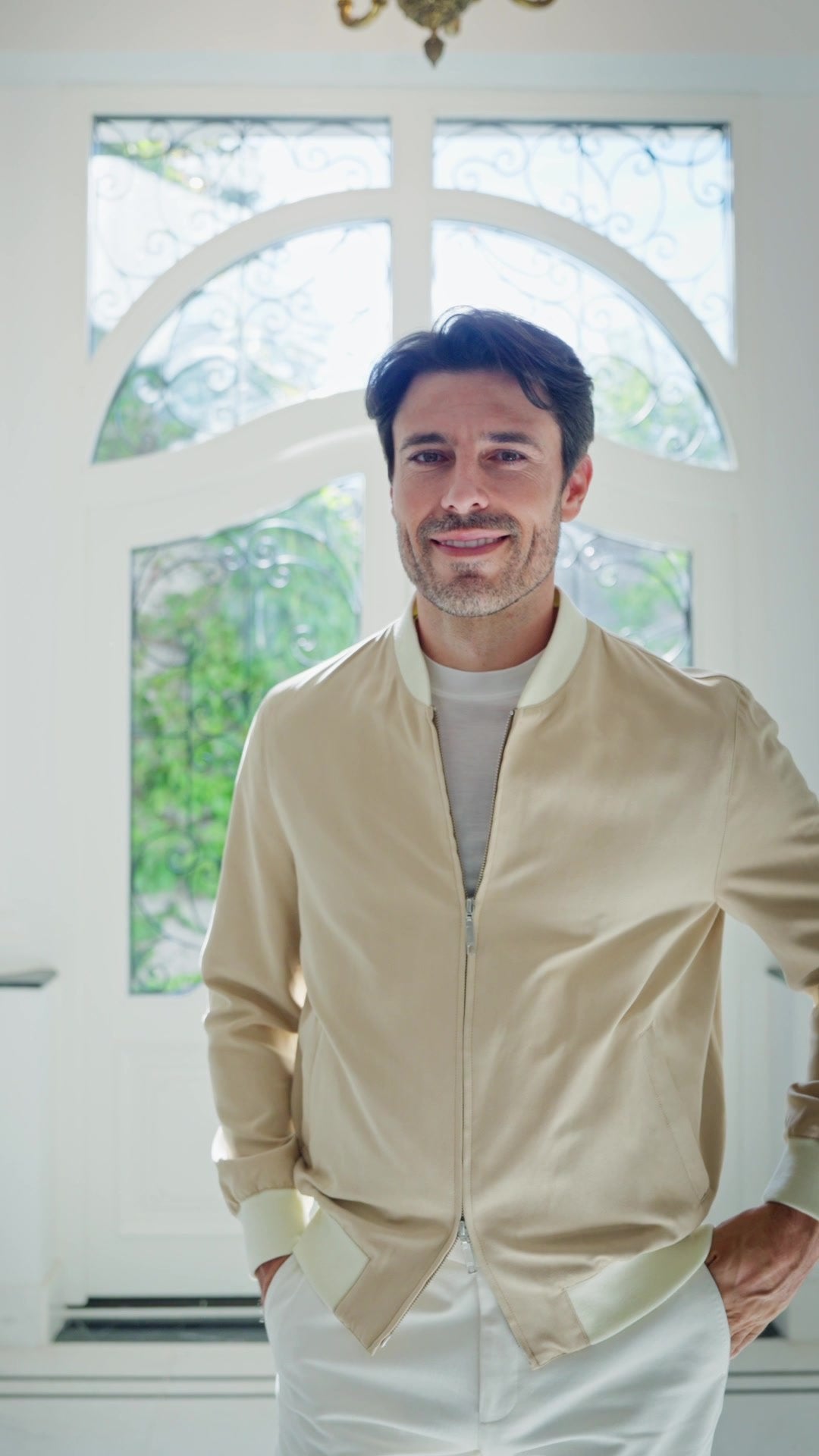 Sand Bomber jacket in motion, in a bright interior