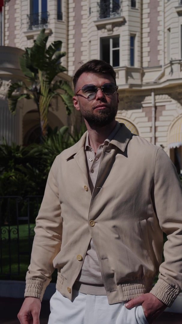 Sand Bomber jacket in a bright urban setting — The Bomber Jacket film