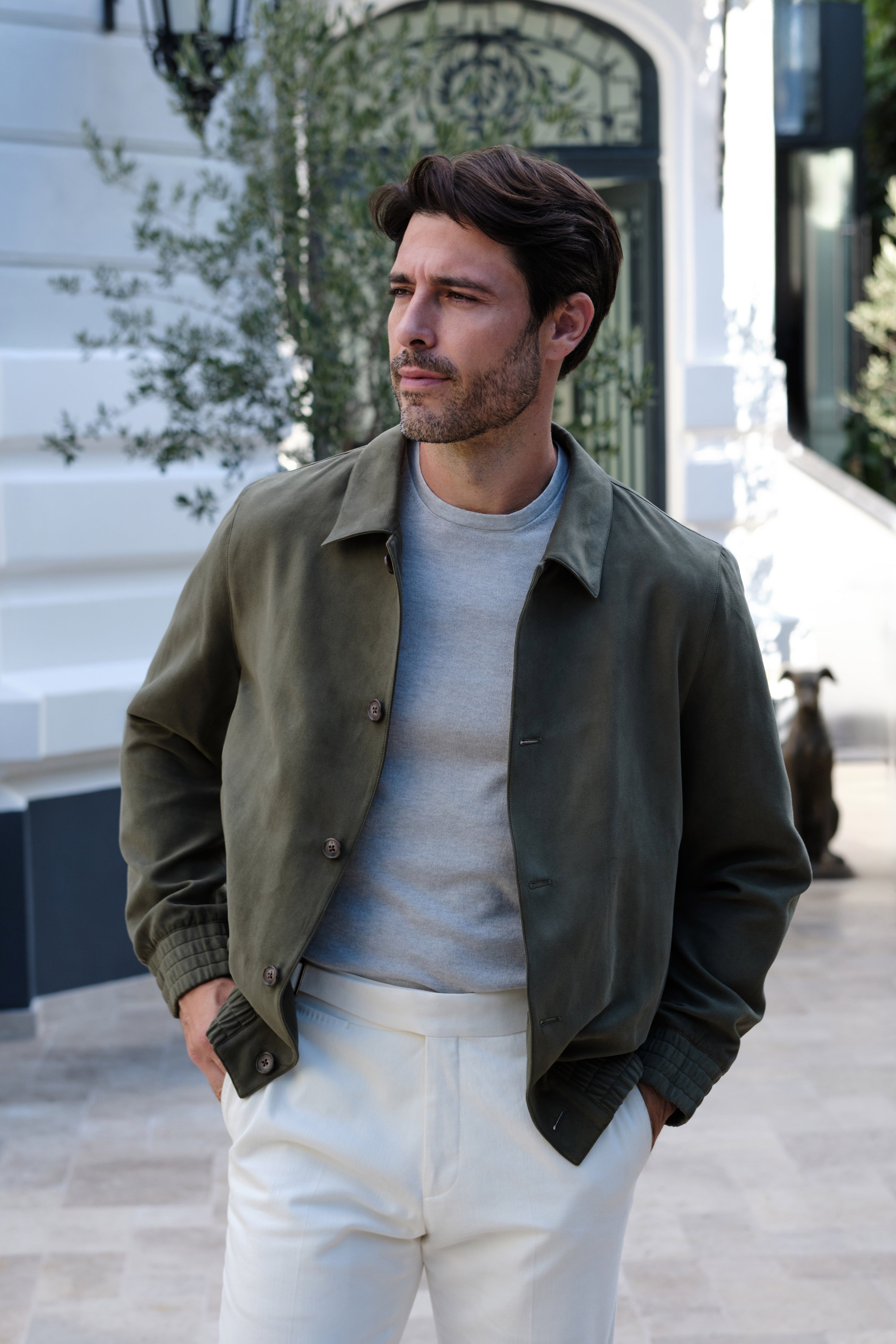 Olive blouson with button closure, worn in a relaxed outfit in light tones