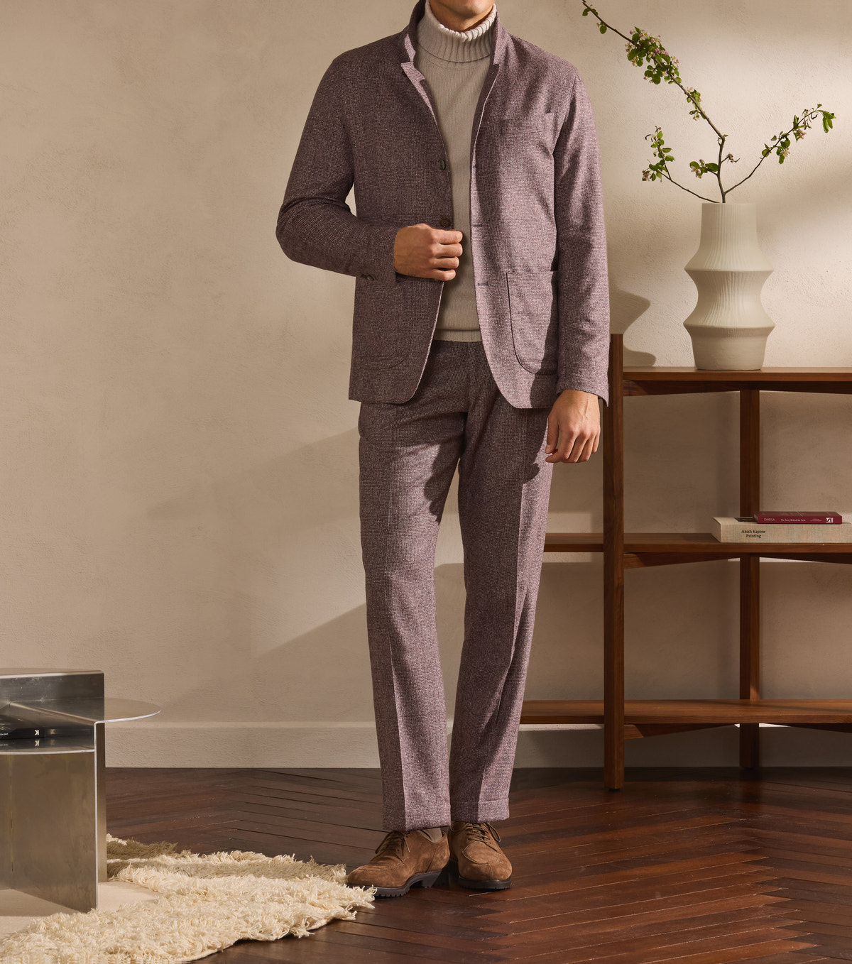 Rose-brown suit worn with a light roll-neck