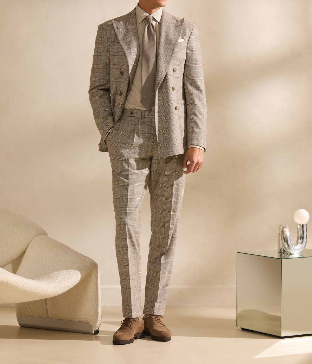 Beige checked double-breasted suit against a bright background
