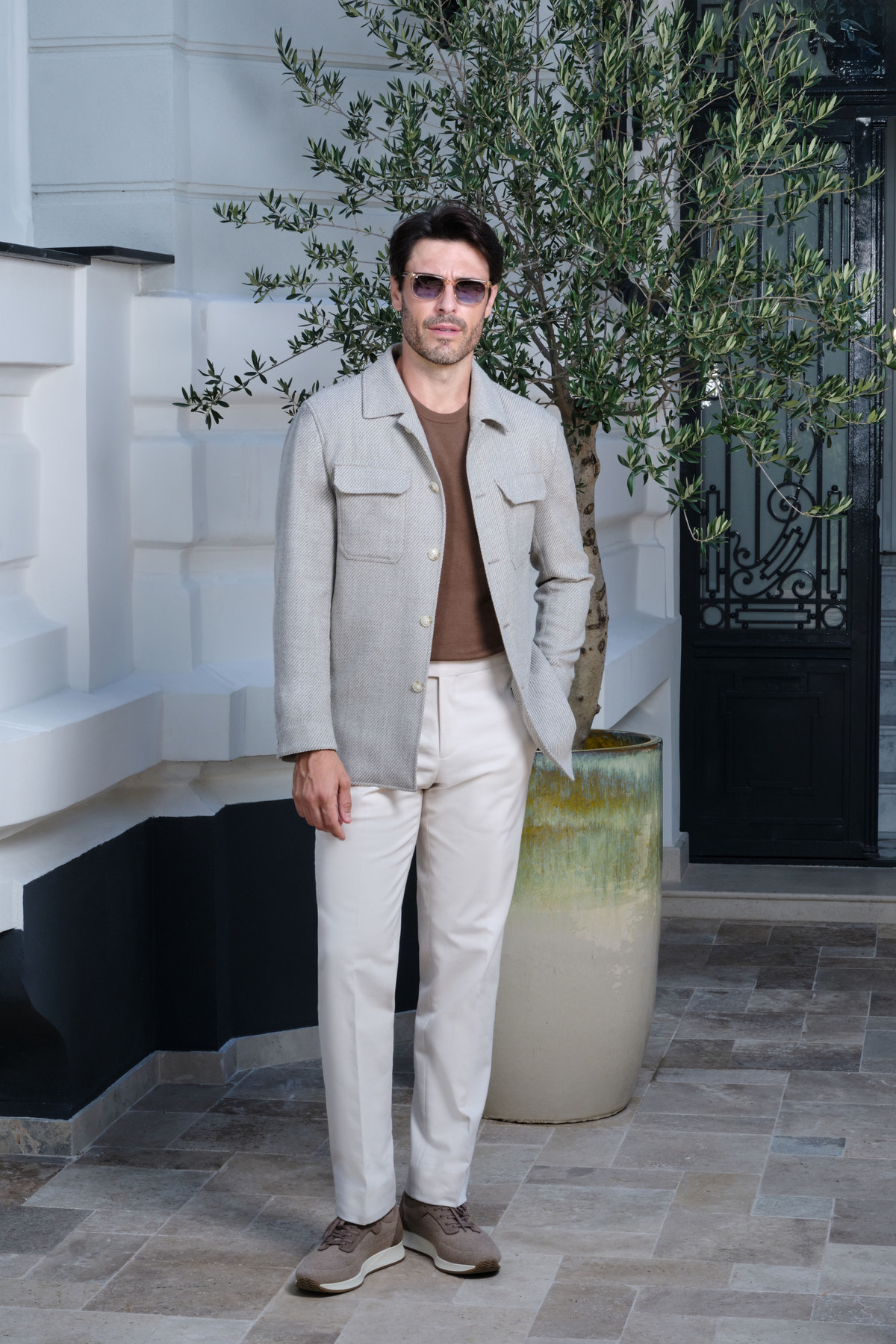 Light grey jacket with patch pockets and white trousers
