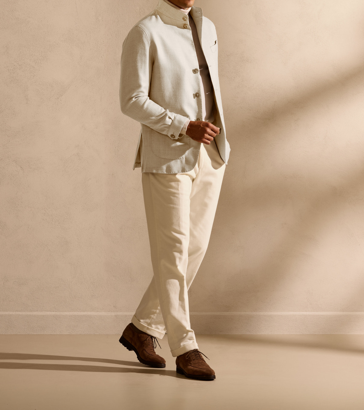 Ivory jacket with a short stand collar and matching trousers