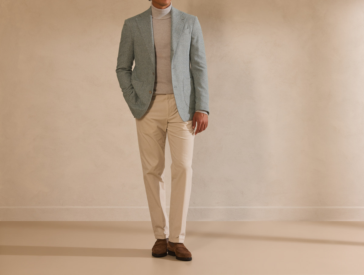 Sage green Consiglieri blazer with a taupe turtleneck and beige trousers