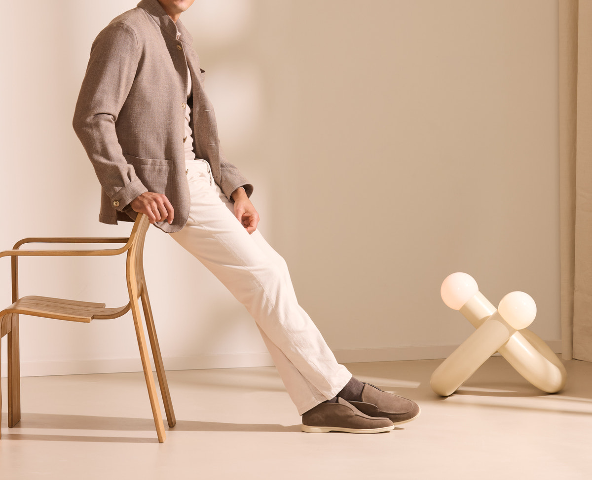 Taupe Consiglieri cardigan with cream trousers in a relaxed ensemble