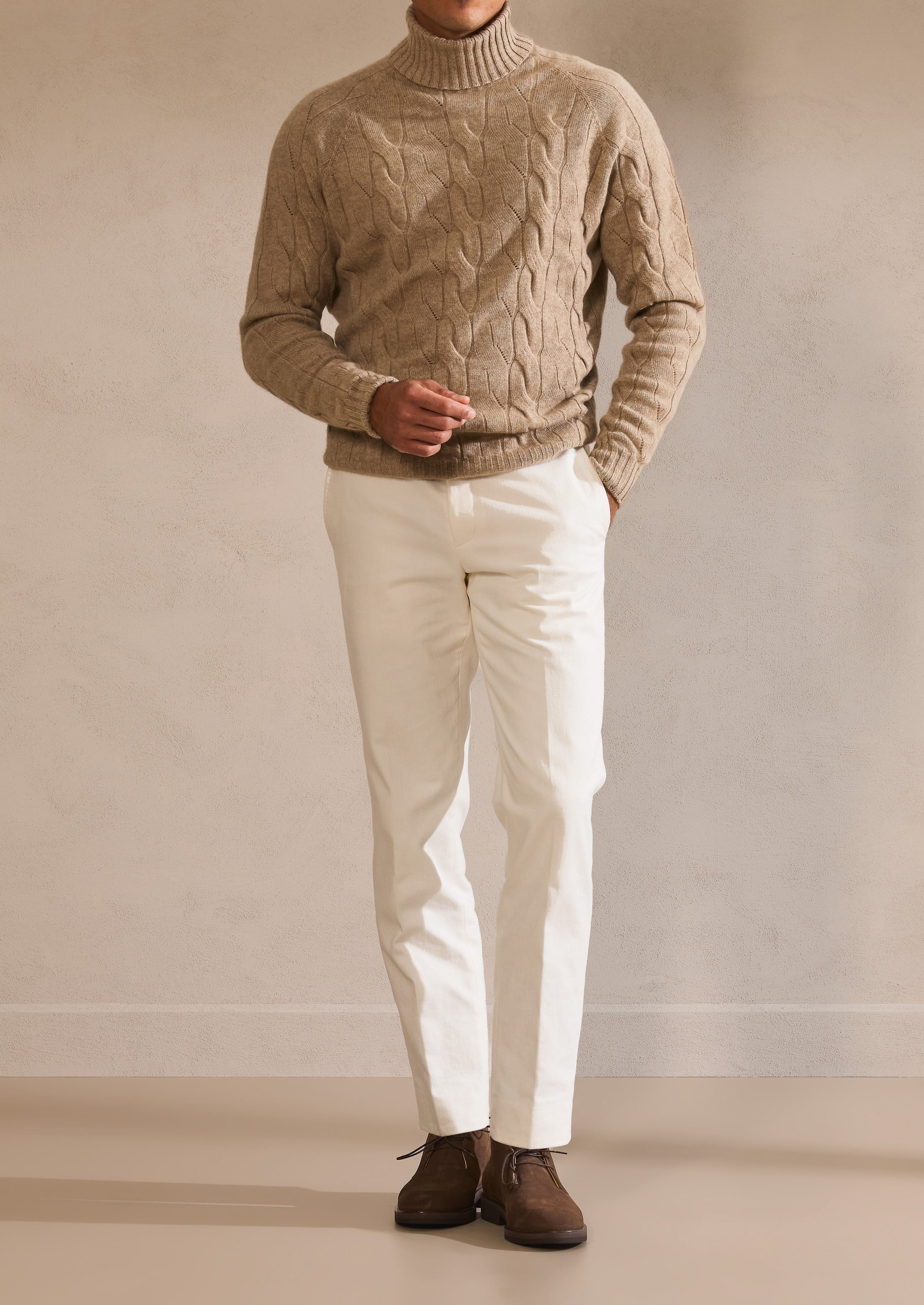 A camel cable-knit sweater, styled with the quiet ease of the Pre-Fall wardrobe.