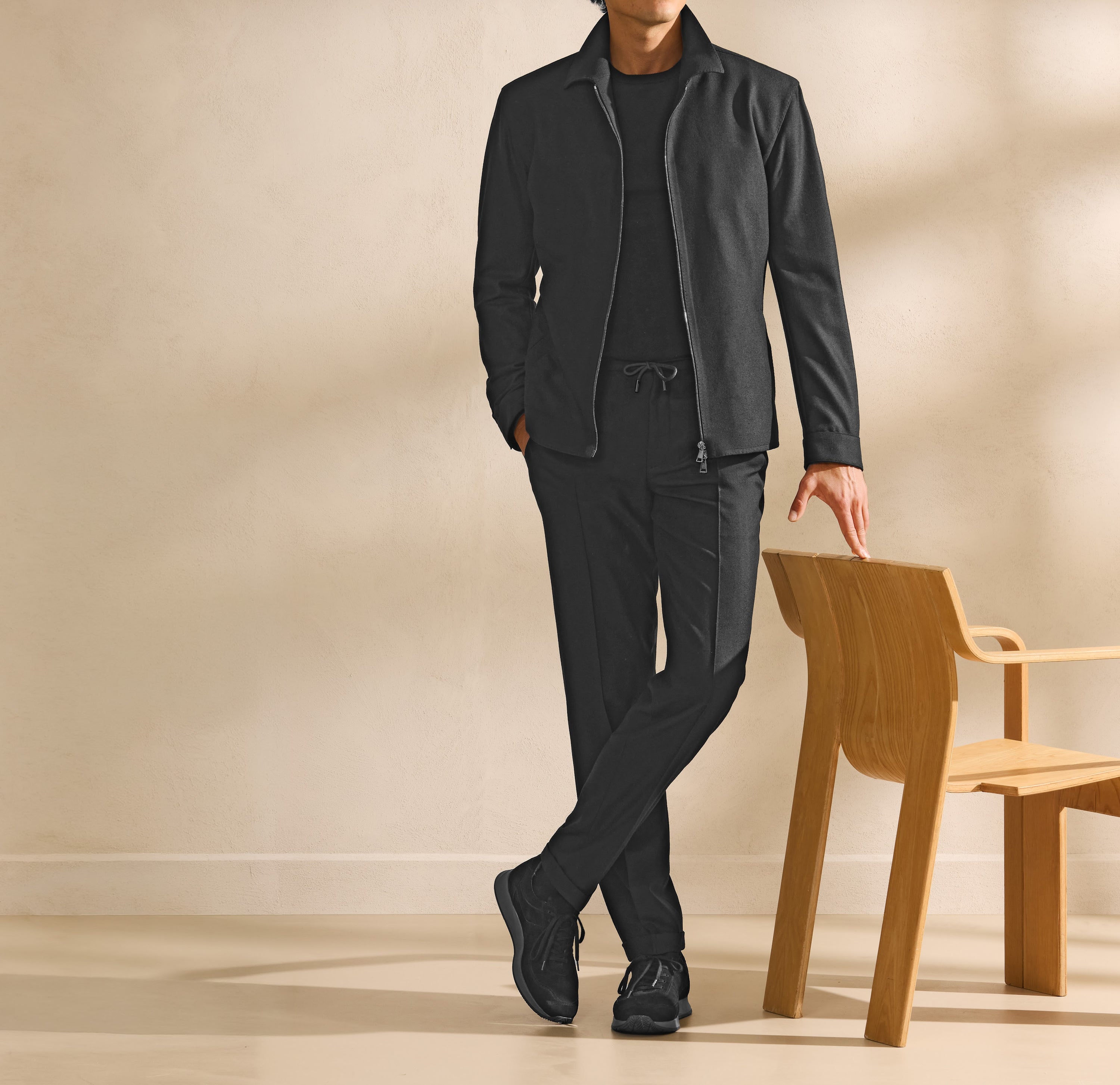 A track set in deep tones, styled as a complete Pre-Fall look.
