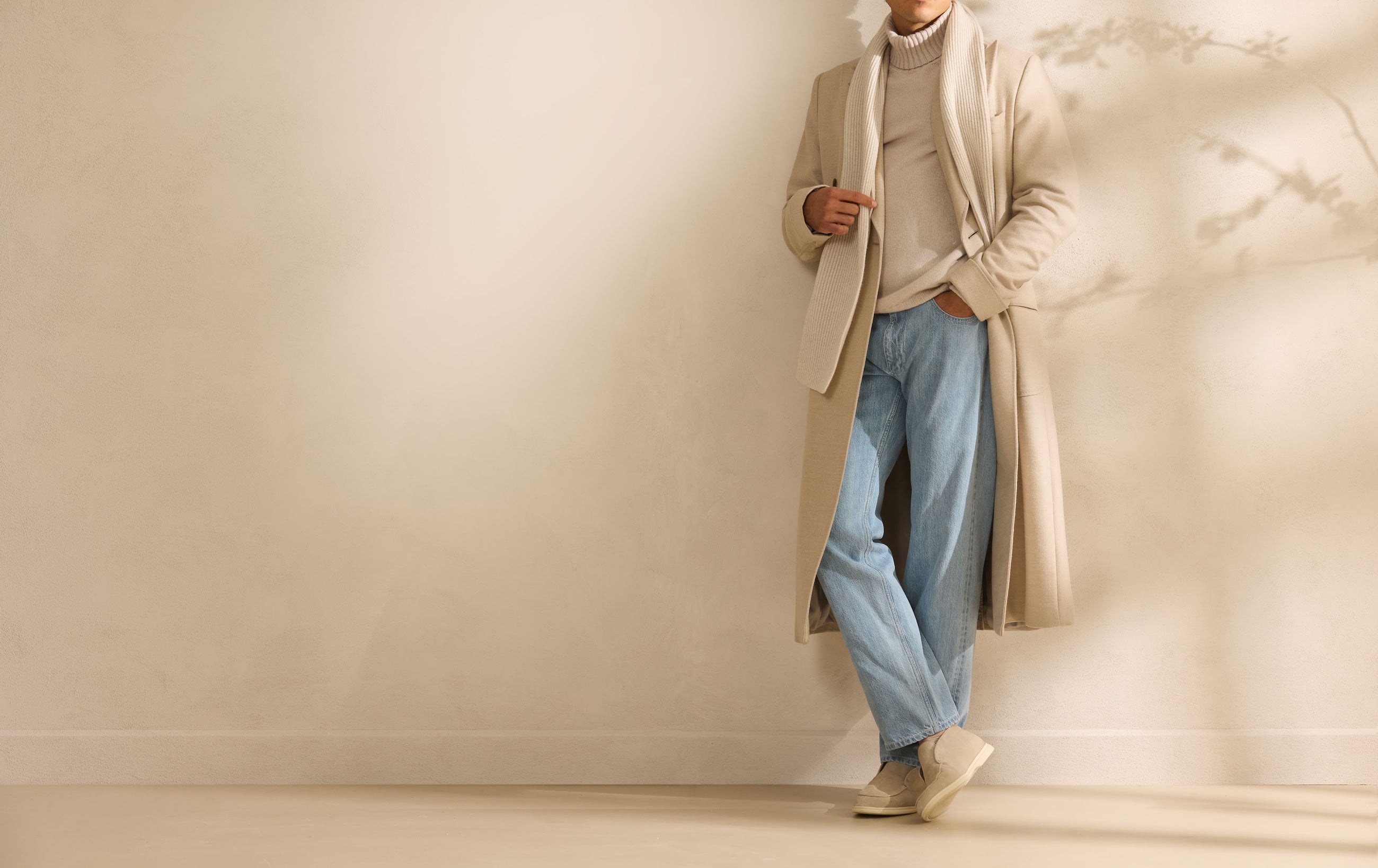 A light Overcoat worn with denim — formal and casual sharing the same frame.