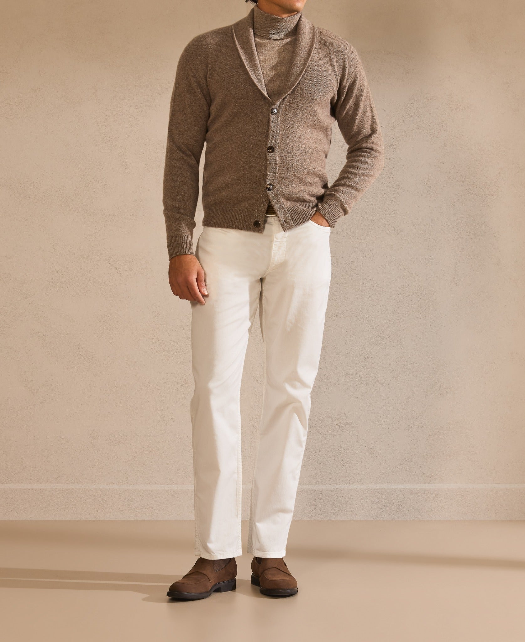 Taupe cardigan over a fine roll-neck, with ivory trousers — warm layers, calm lines.