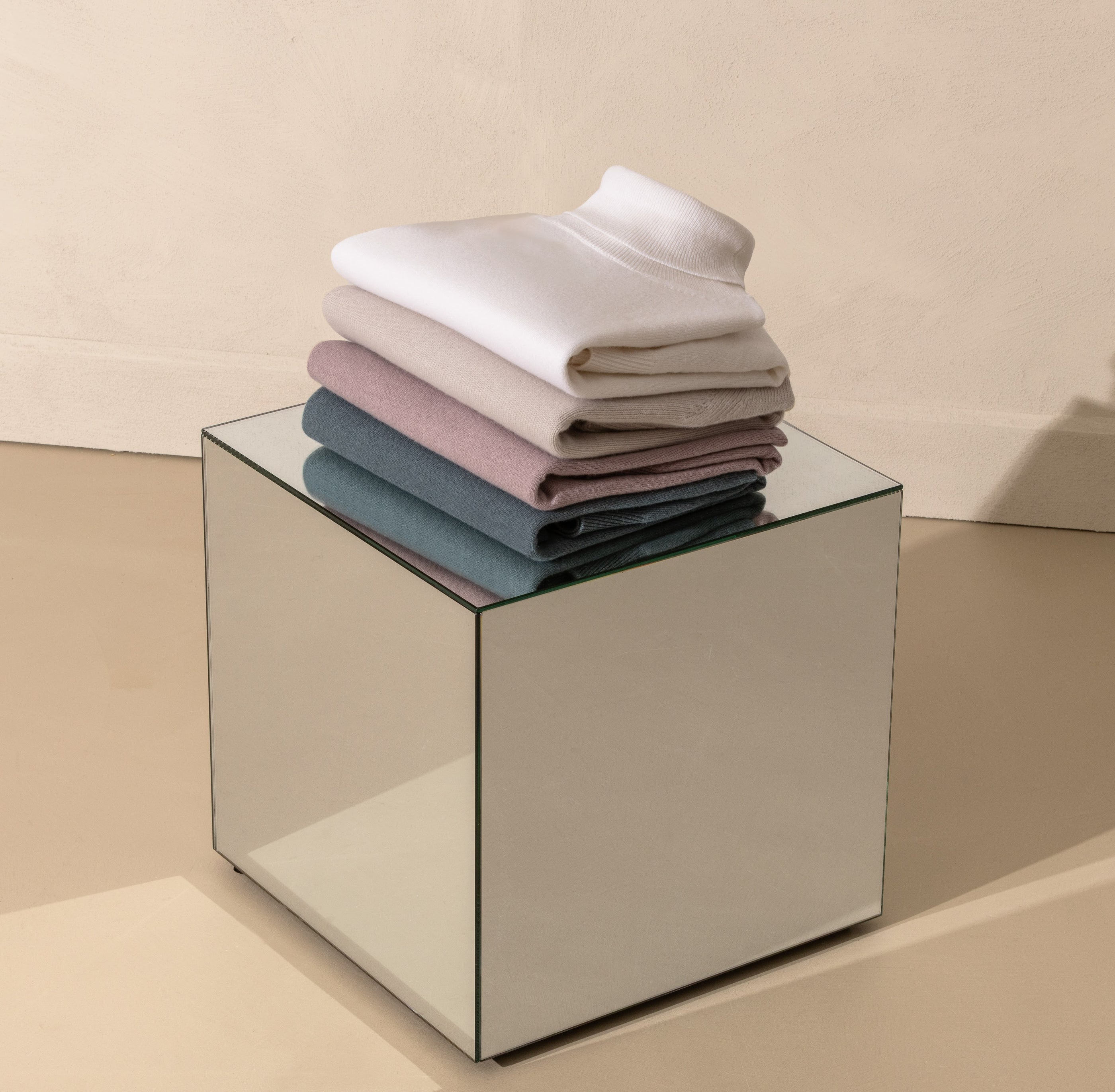 A considered palette of Consiglieri knitwear in neutral and pastel tones.