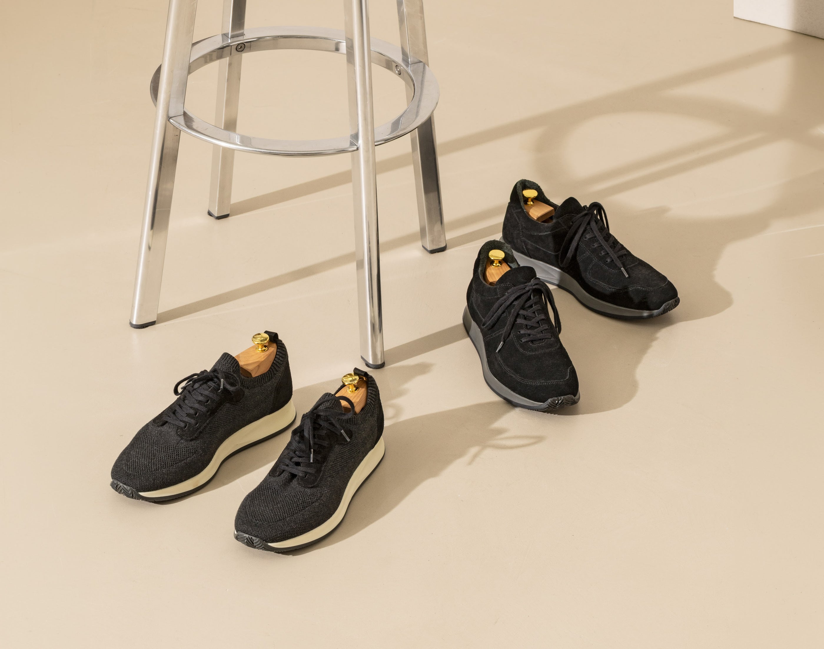 Two pairs of runners, in technical knit and suede — one line, two expressions.
