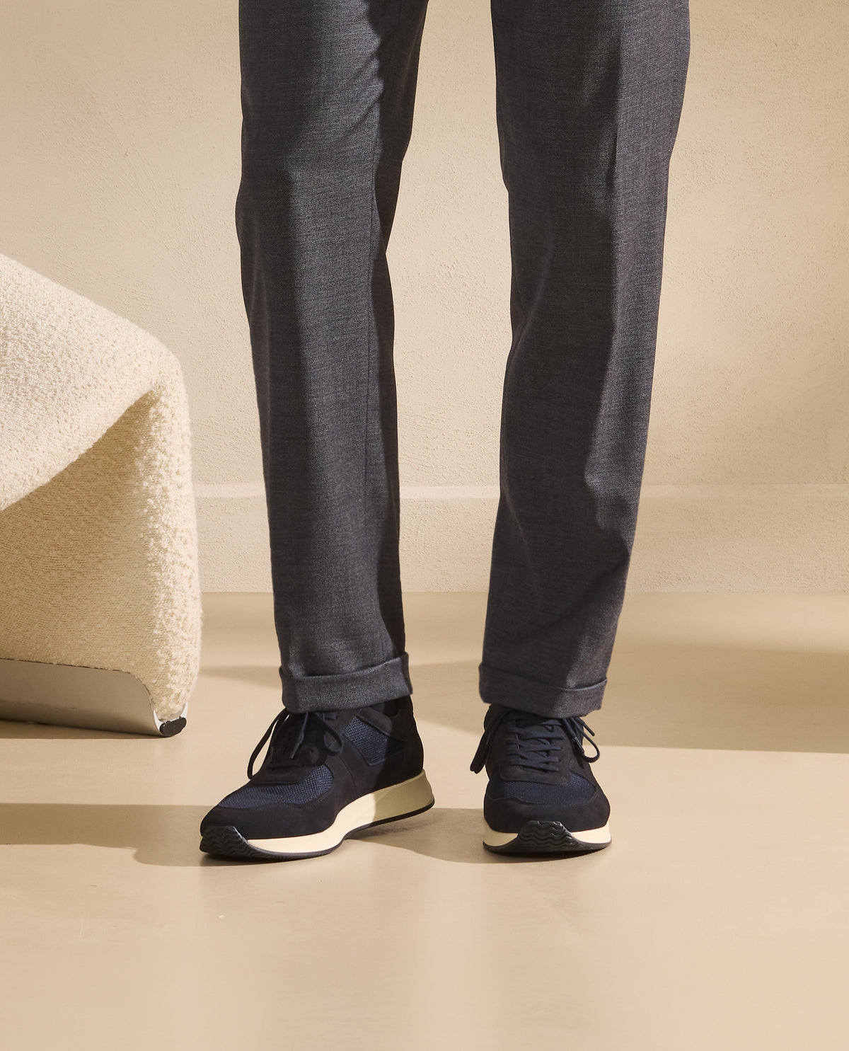Navy Runners worn with grey wool trousers — the sporting accent of a refined outfit.
