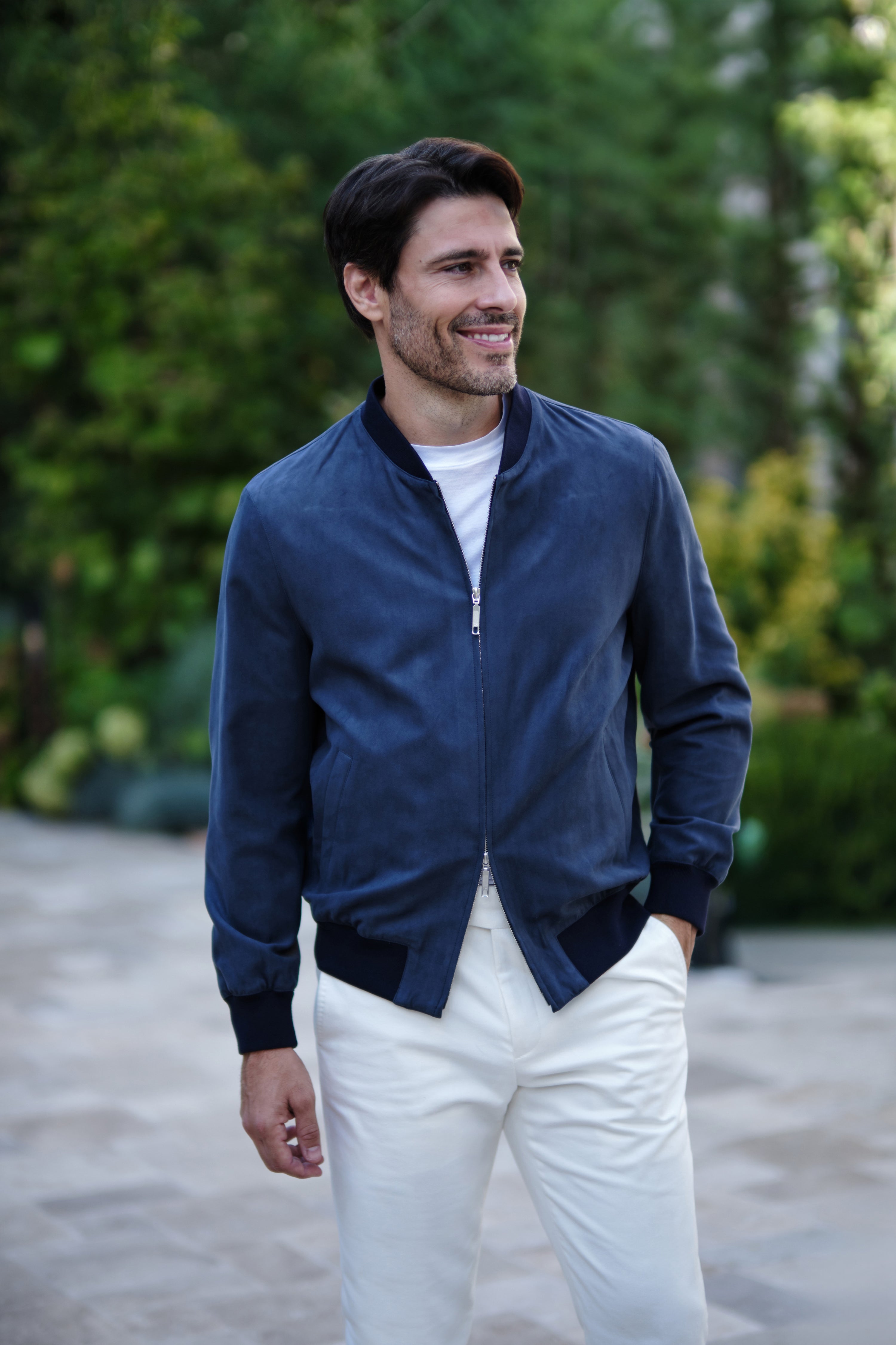 Navy Bomber jacket in an outdoor portrait, worn with a white top