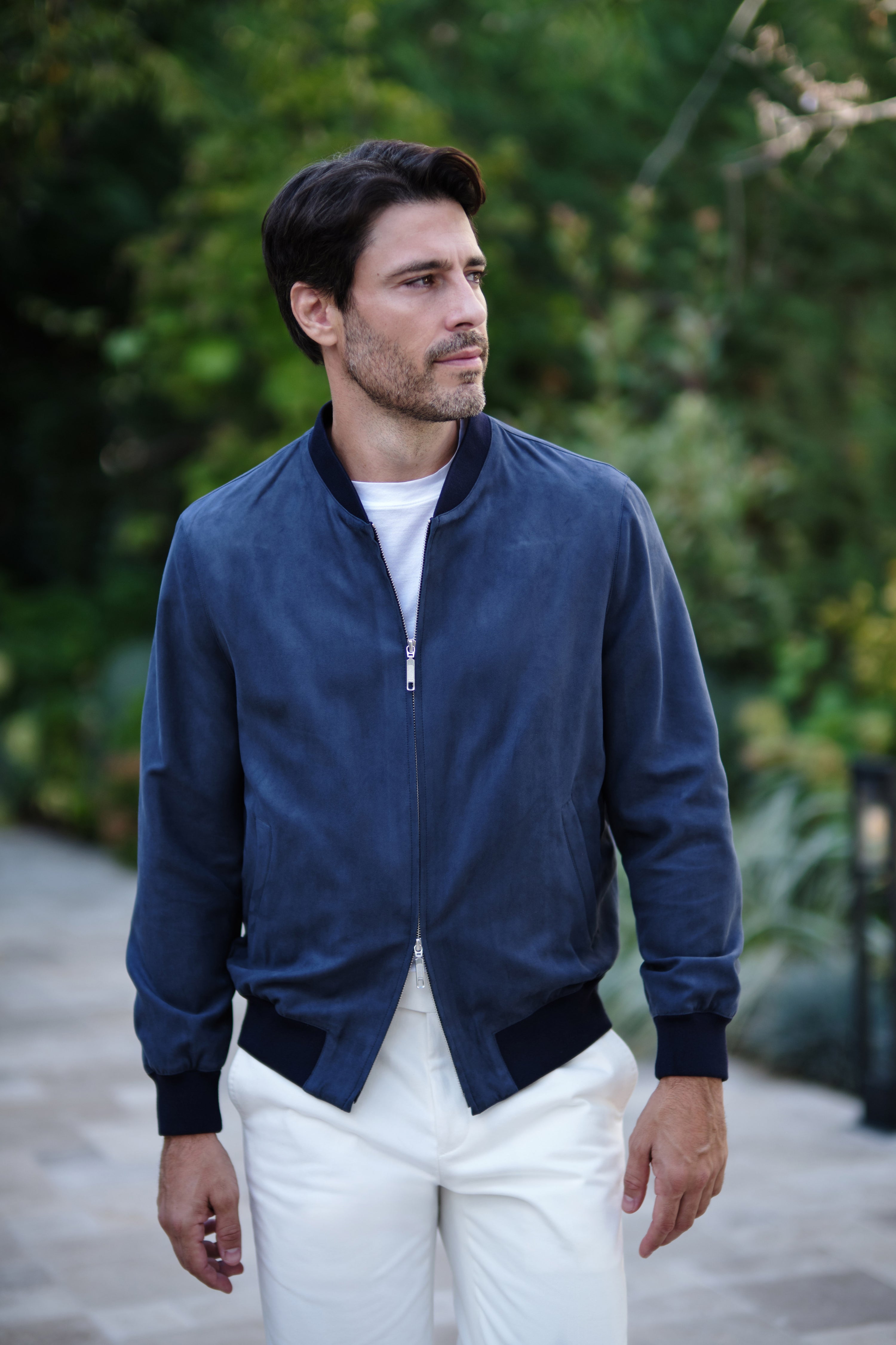 Outdoor portrait with a navy Bomber jacket and white trousers