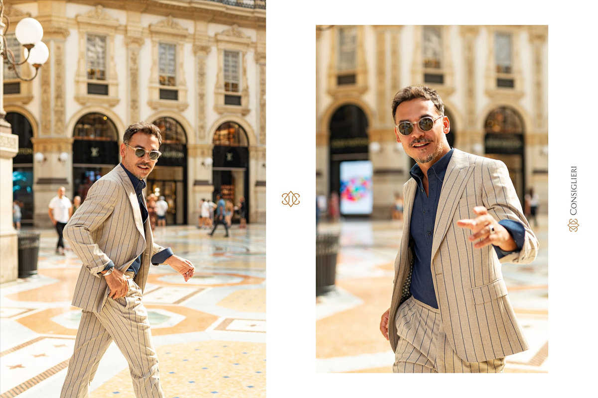 Beige striped Consiglieri suit with a navy sweater in the city
