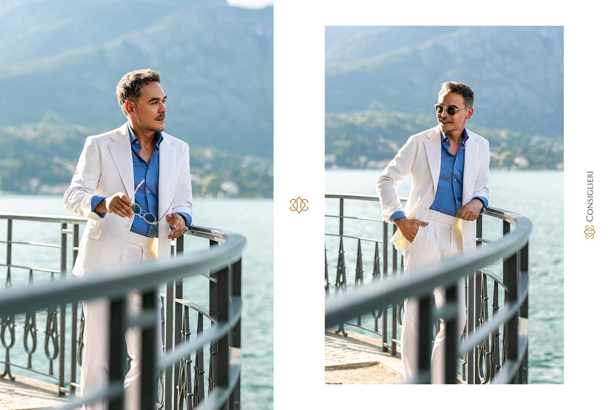 White Consiglieri blazer with a pale blue shirt and cream trousers on a terrace