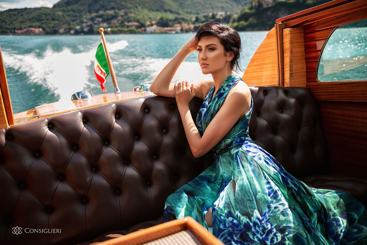 Green and blue printed dress photographed aboard a wooden boat