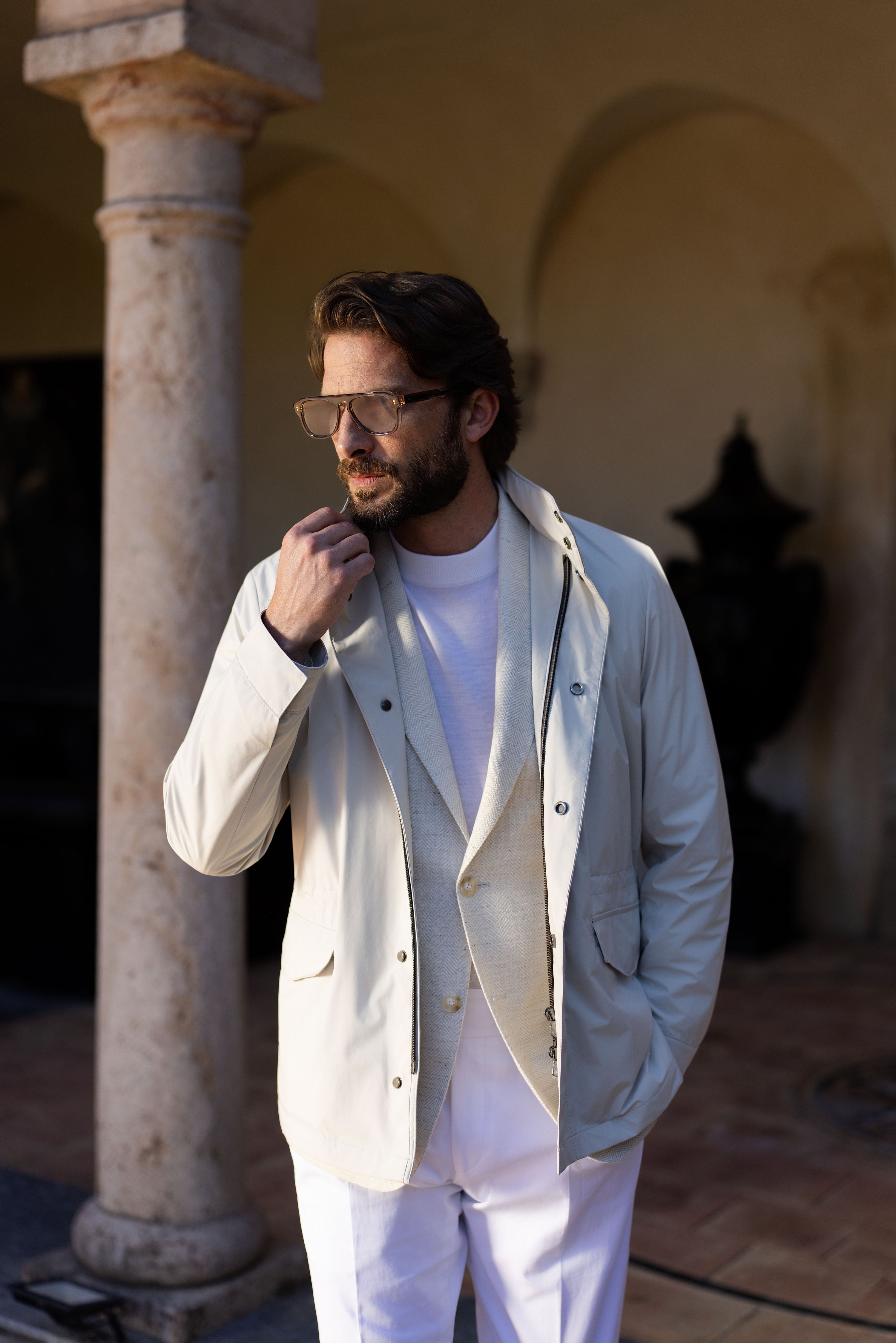 Detail of a Consiglieri outfit with a light-coloured blouson worn over a jacket
