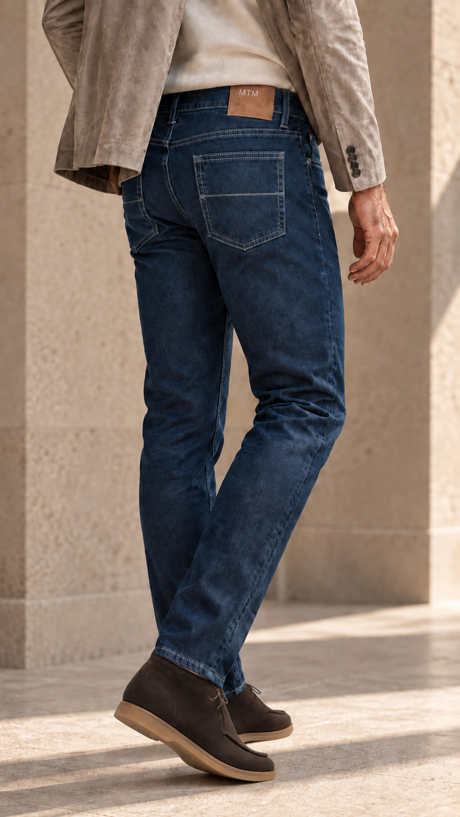 Rear view of the look with indigo denim and a greige blazer.