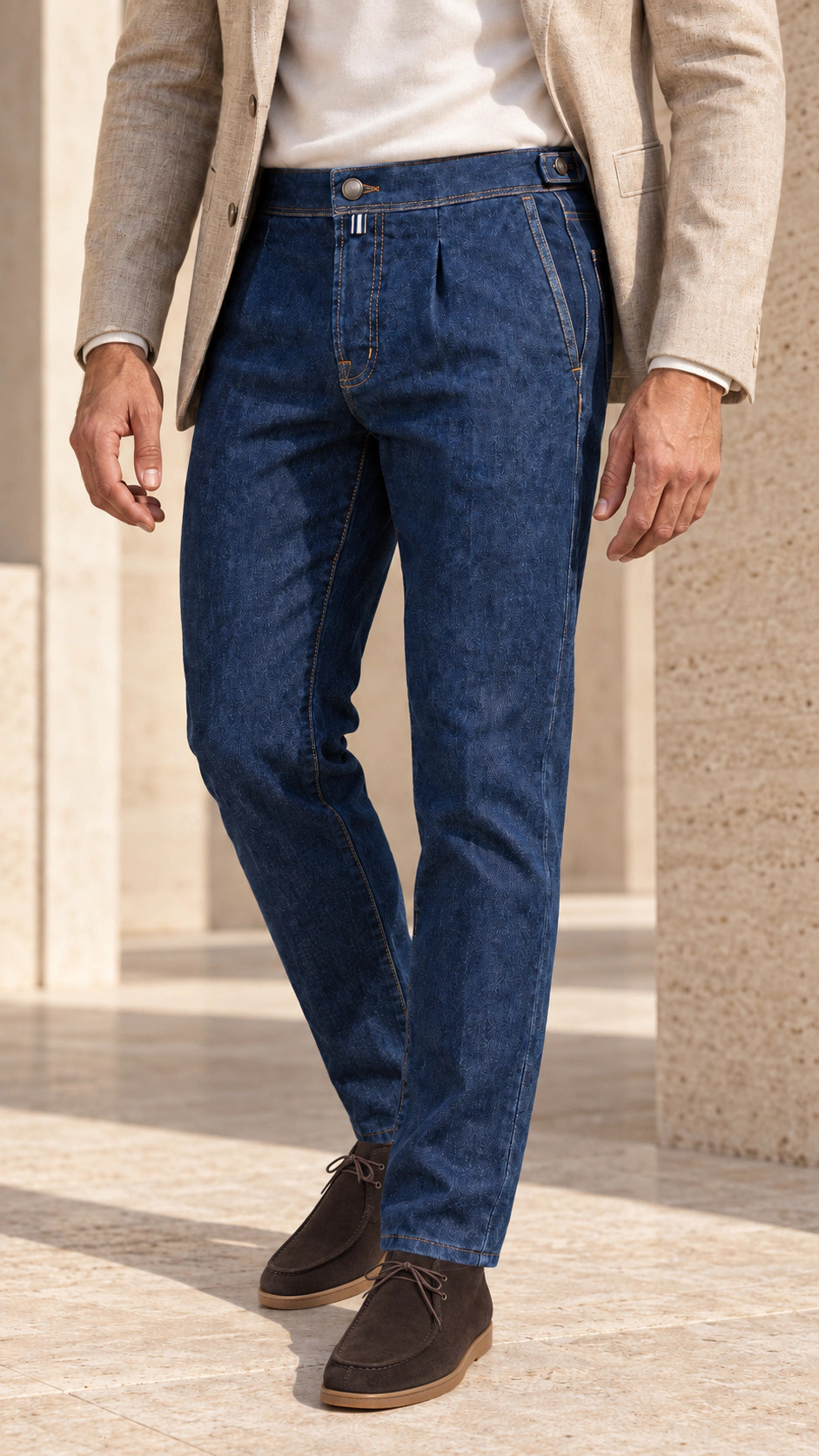 Front close-up of the look with denim trousers and an oatmeal blazer.