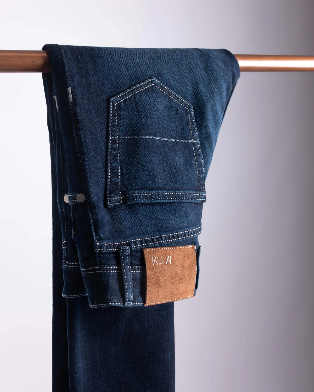 Indigo denim with light stitching and a personalised MTM patch.