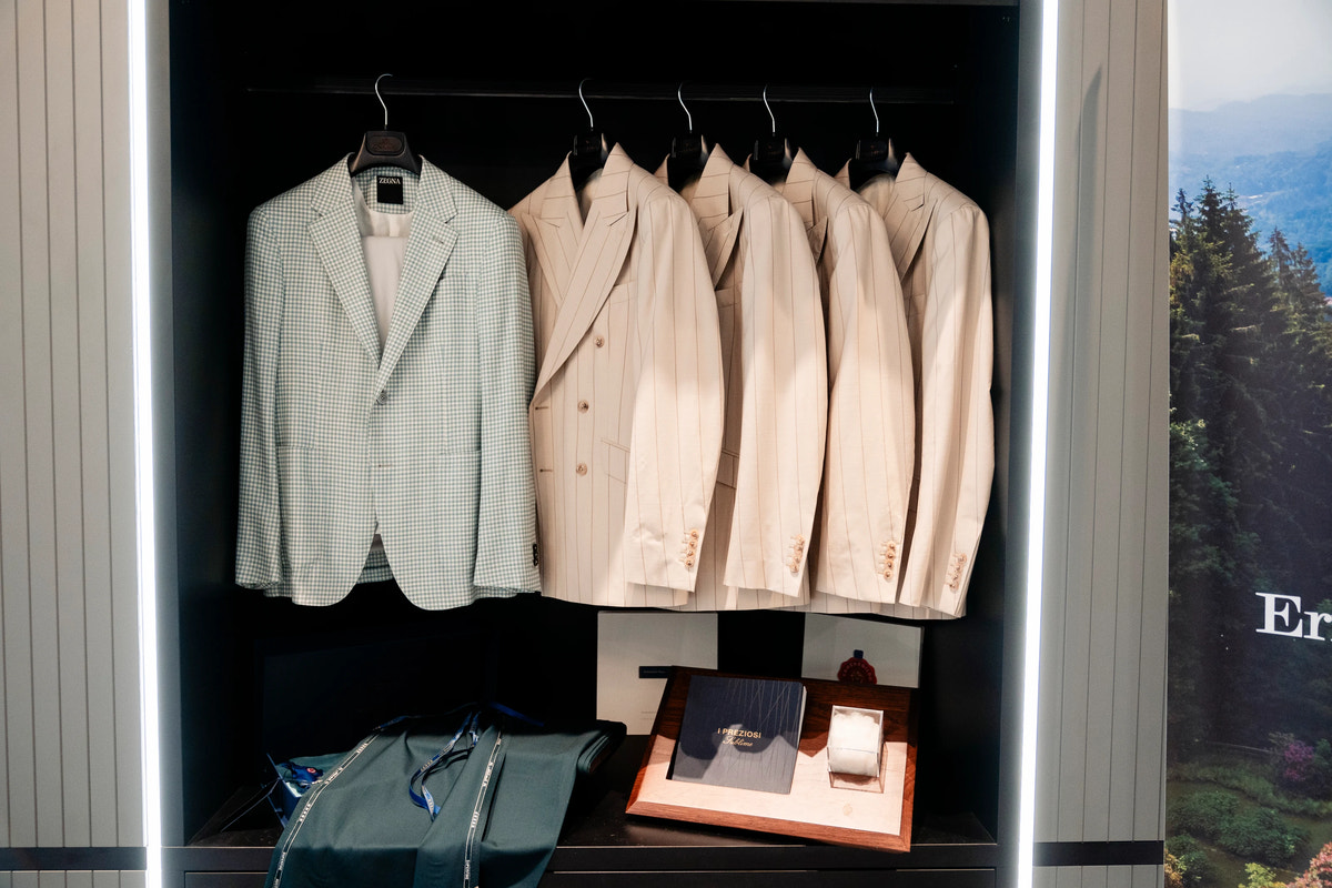 Light-toned jackets displayed against a dark backdrop.