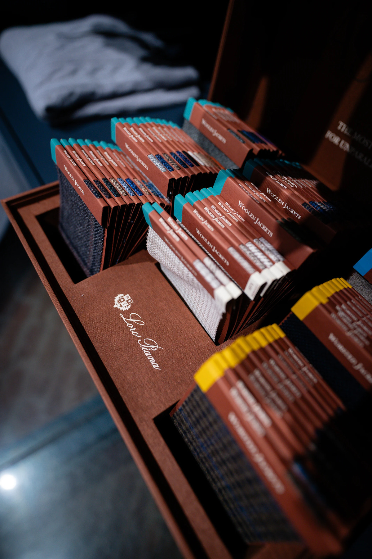 Open Loro Piana fabric books, showing the cloth selection.