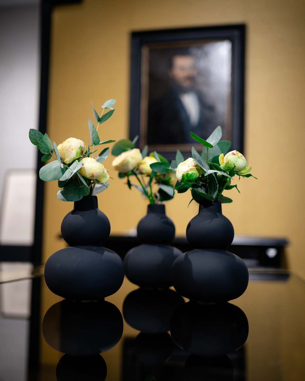 Flowers and black vases on the display table.