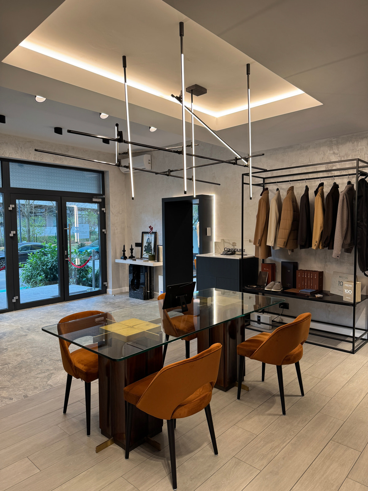 The wardrobe consultation area in warm tones, beside the glazed entrance.