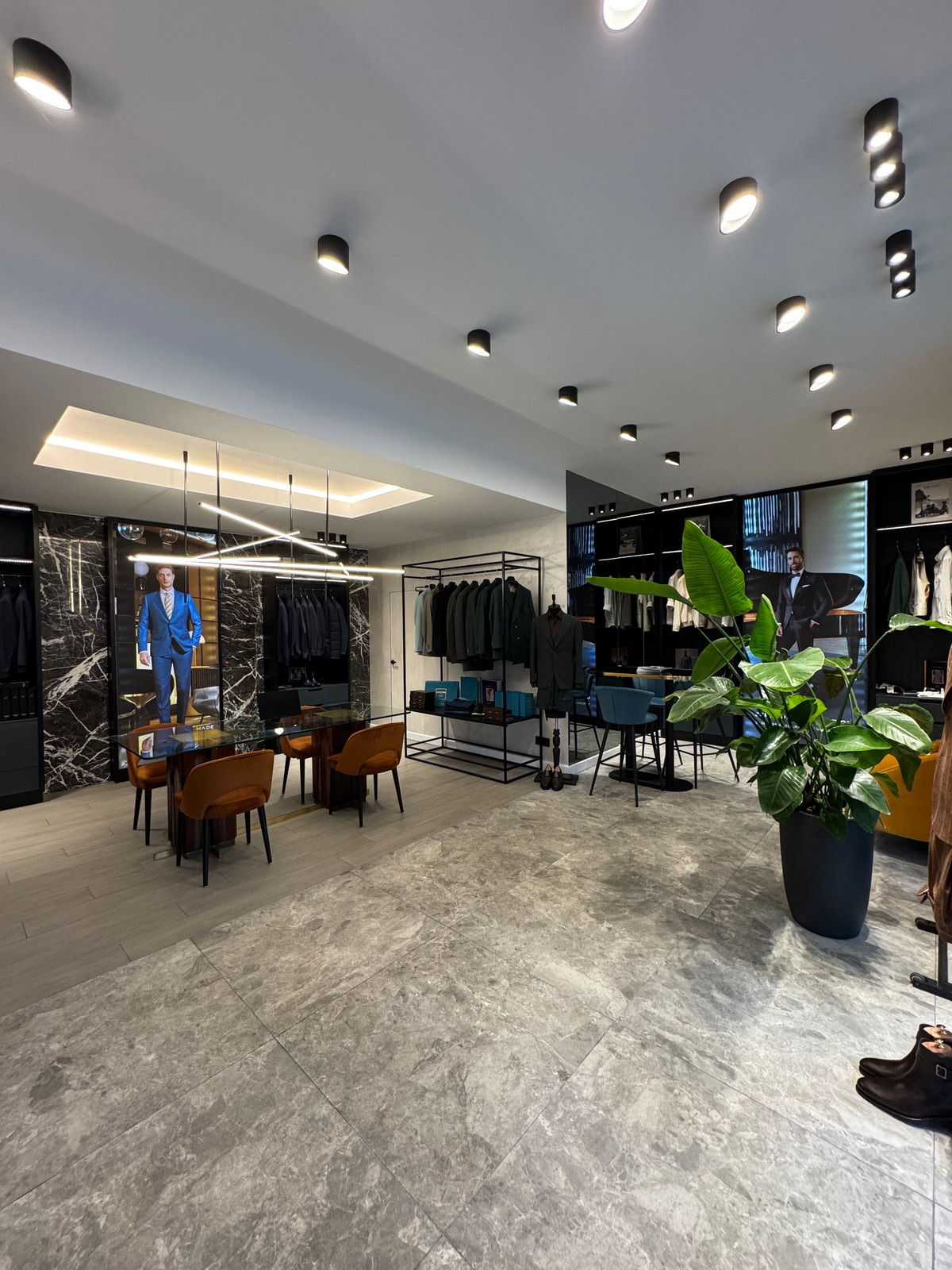 A wide view of the interior, with clothing displays and pendant lighting.