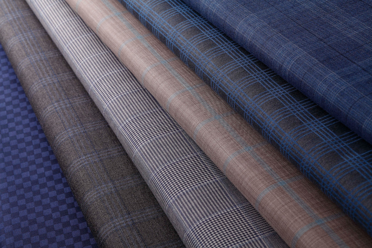 Fabrics in grey, taupe and blue arranged in a fan