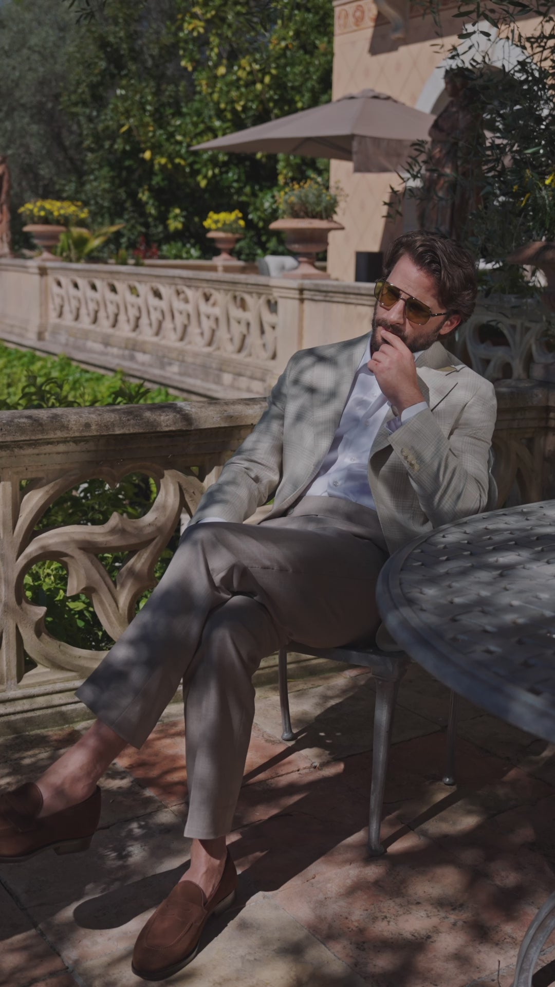 Consiglieri Menton blazer with brown trousers beside a stone table