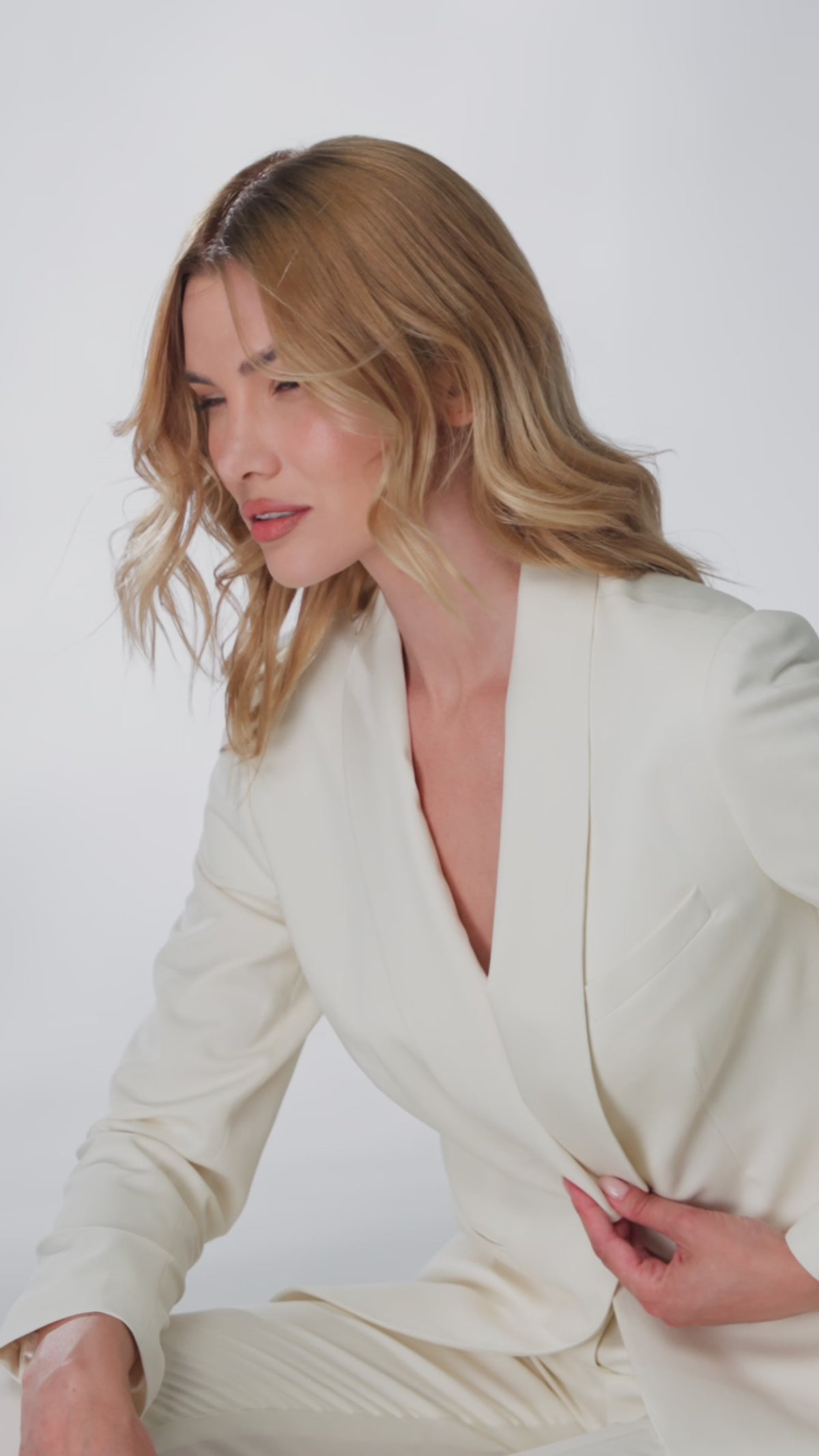 Women’s ivory jacket with wide lapels, photographed from the side
