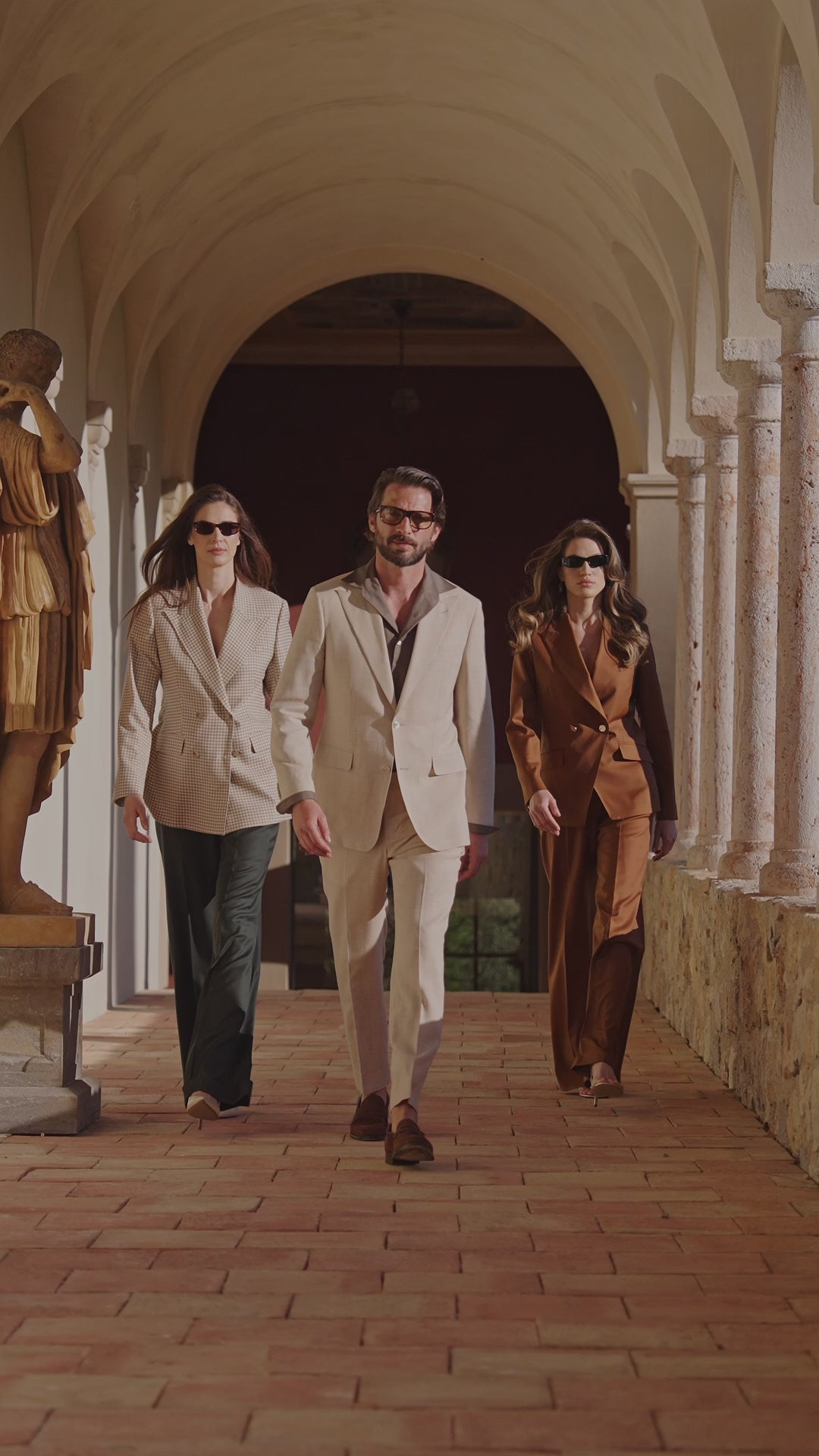 Three Consiglieri looks in white, cream and copper beneath a colonnade