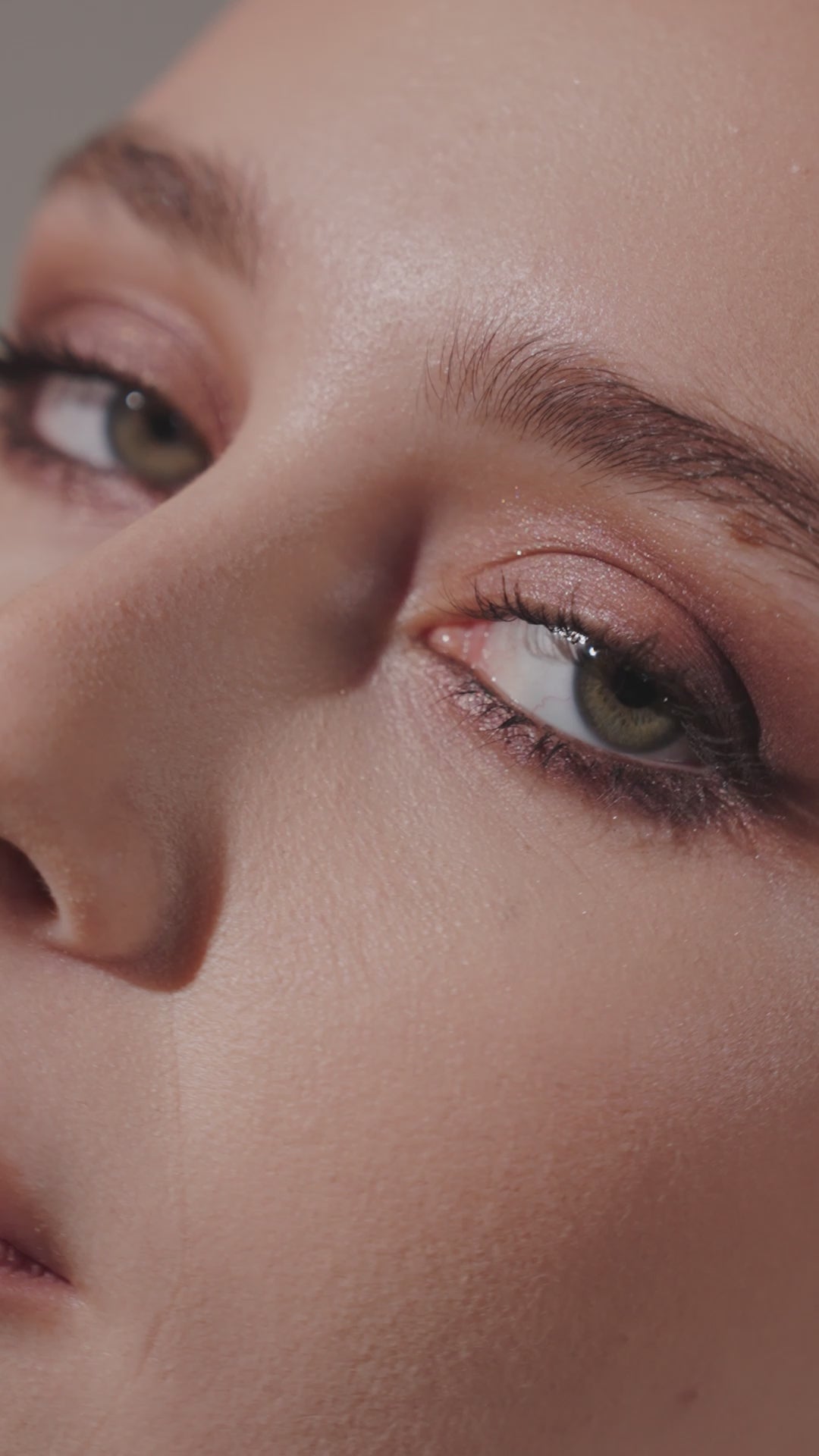 A woman's gaze framed by eyelashes and warm-toned eye makeup, Consiglieri