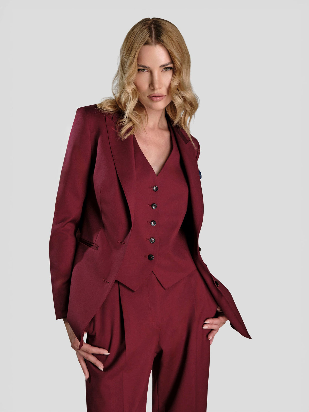 Women’s burgundy three-piece suit with a waistcoat and wide-leg trousers