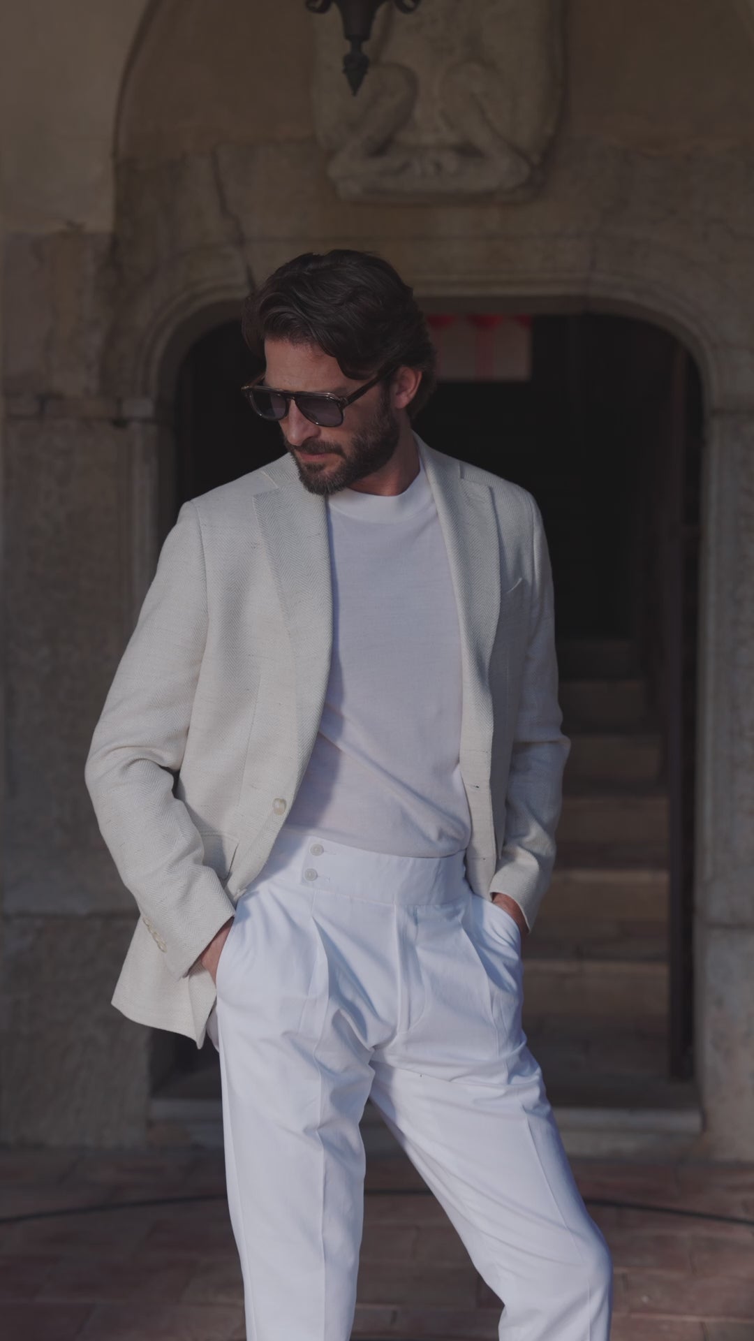 Ivory Consiglieri Ferla Amalfi blazer with a knit top and white trousers