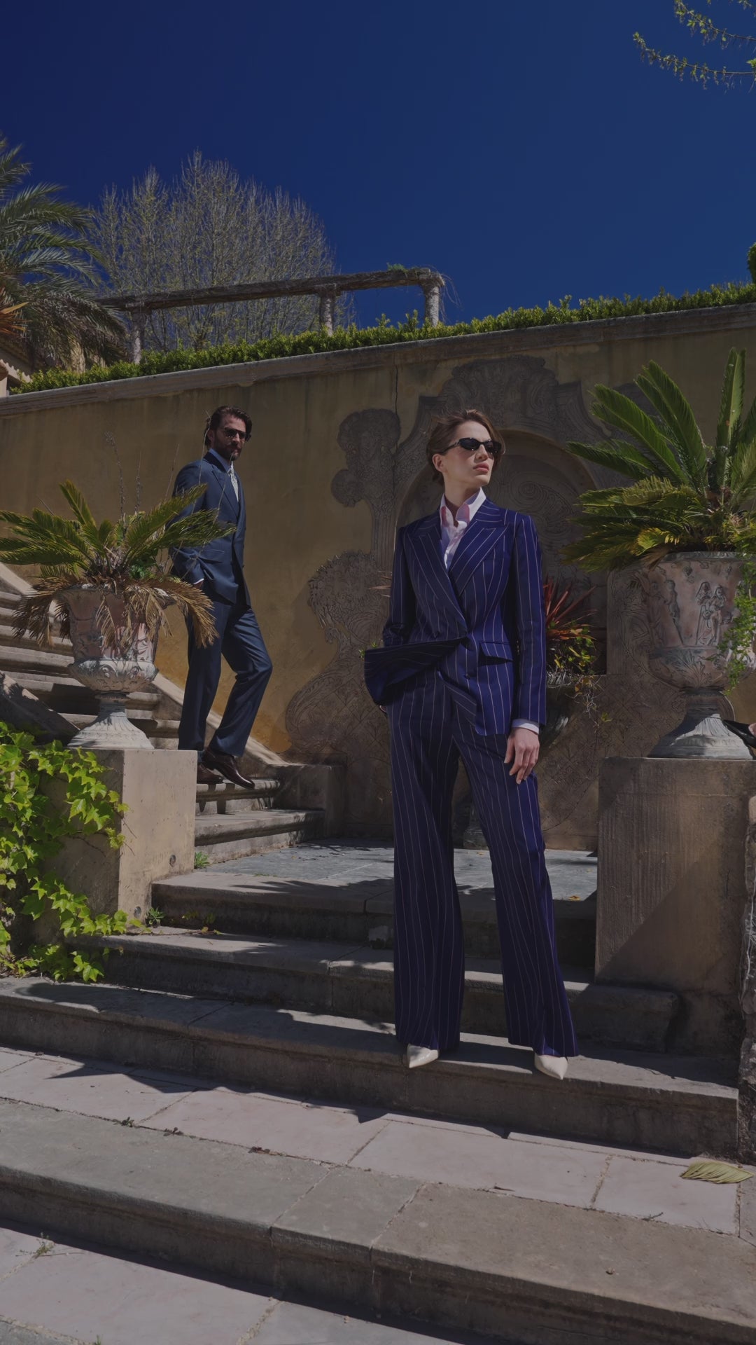 Navy Consiglieri Monte-Carlo women's suit with a fitted blazer on stone steps