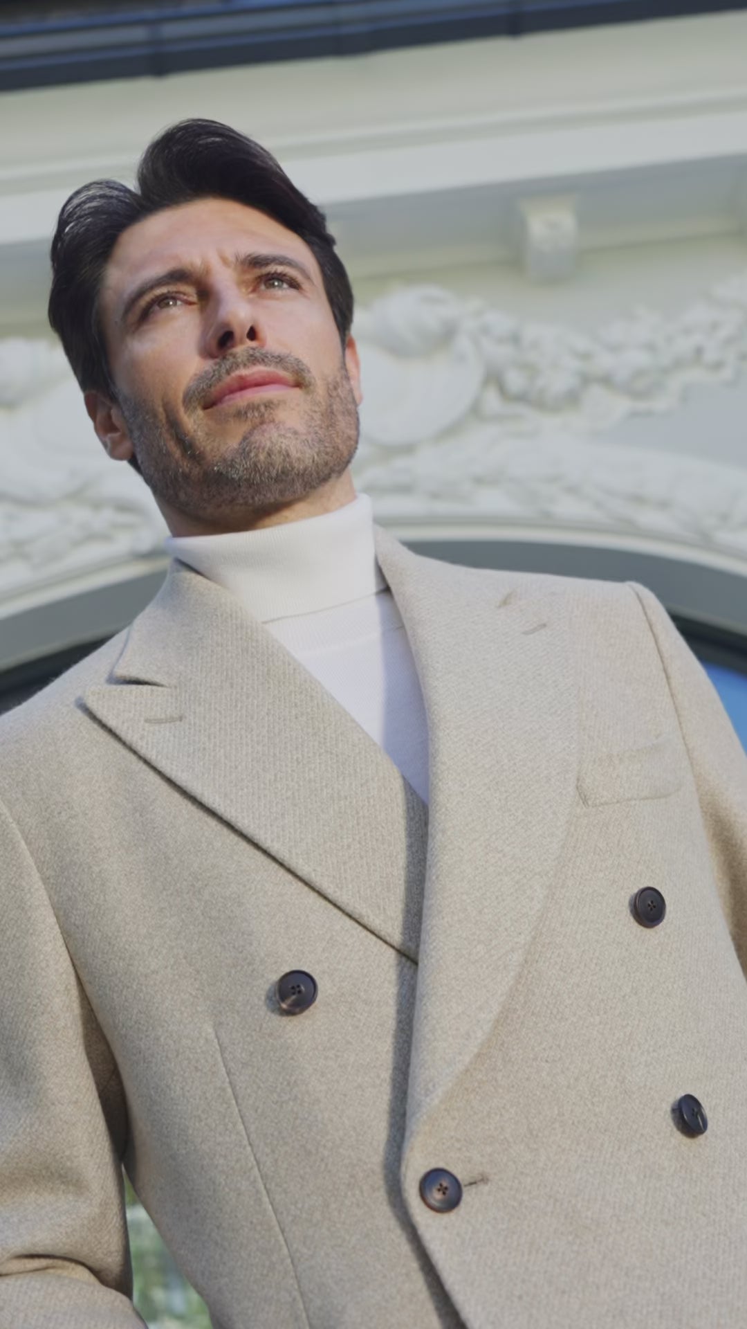Beige double-breasted overcoat over an ivory roll-neck sweater