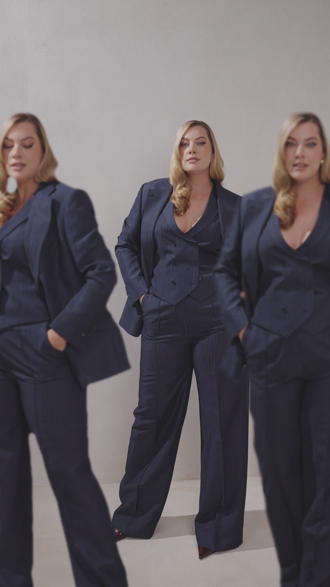Three women in navy Consiglieri The Signature Suit ensembles with jackets, waistcoats and trousers