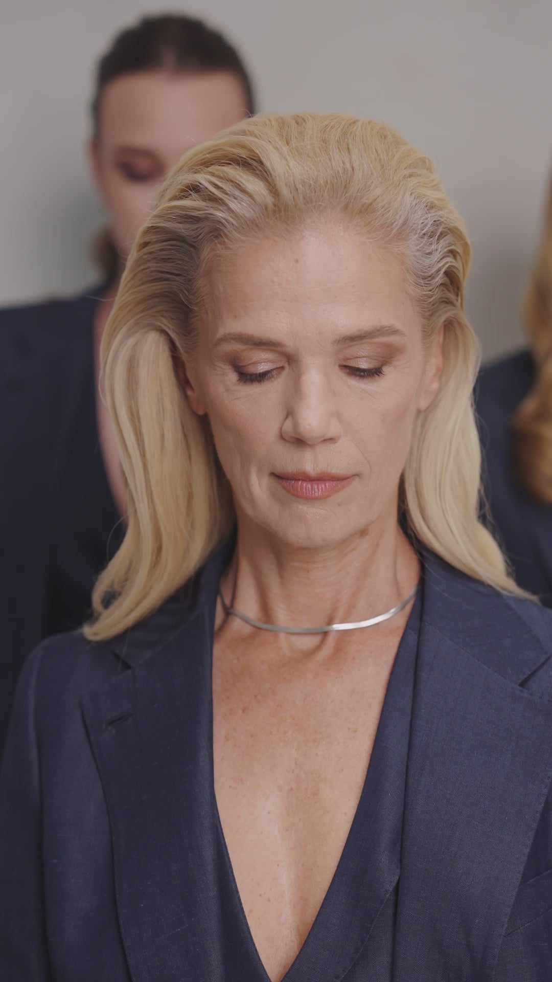 Navy Consiglieri The Signature Suit blazer with a V neckline and fine necklace